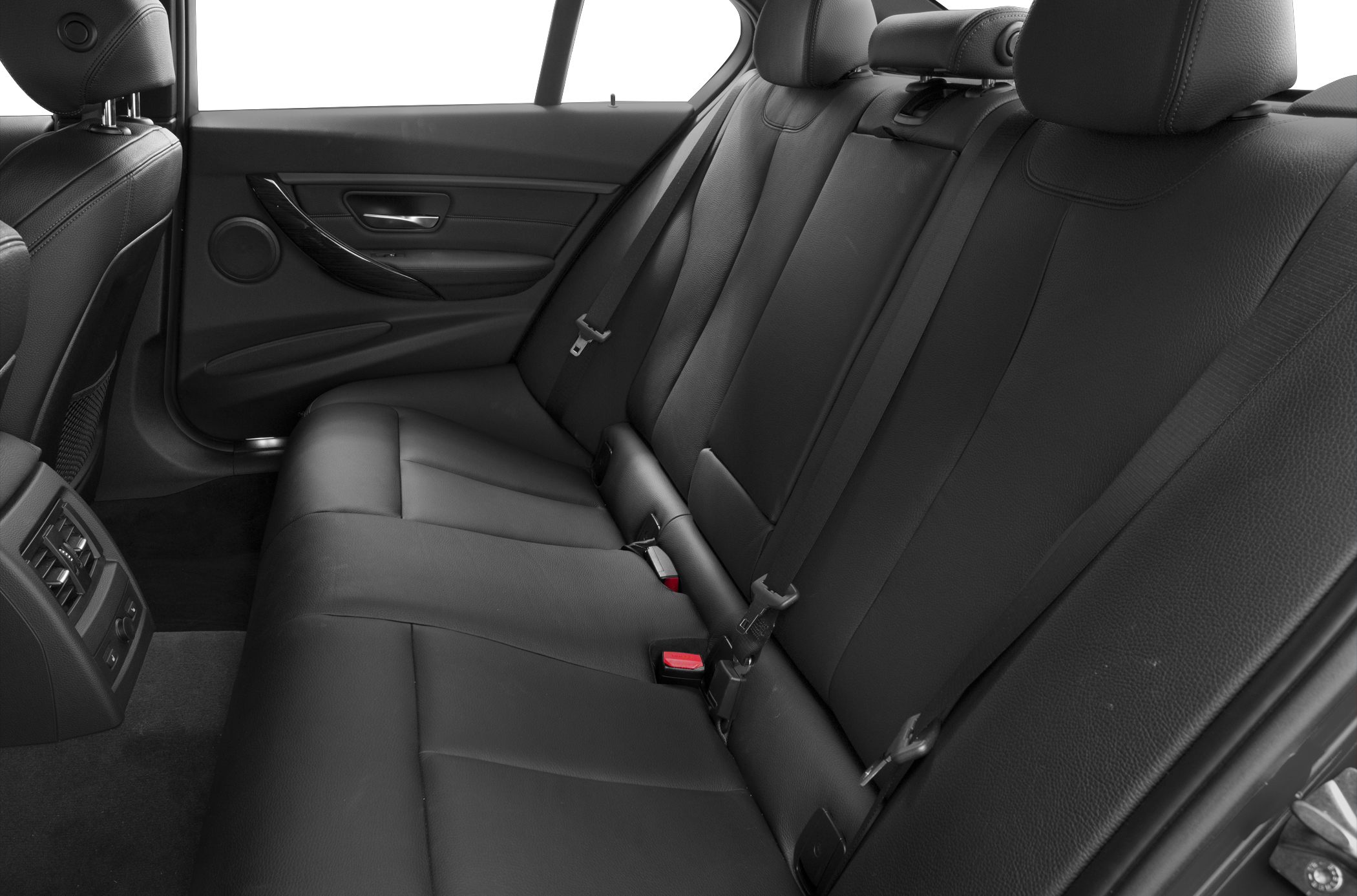Rear cabin with black leather seats and air conditioning vents