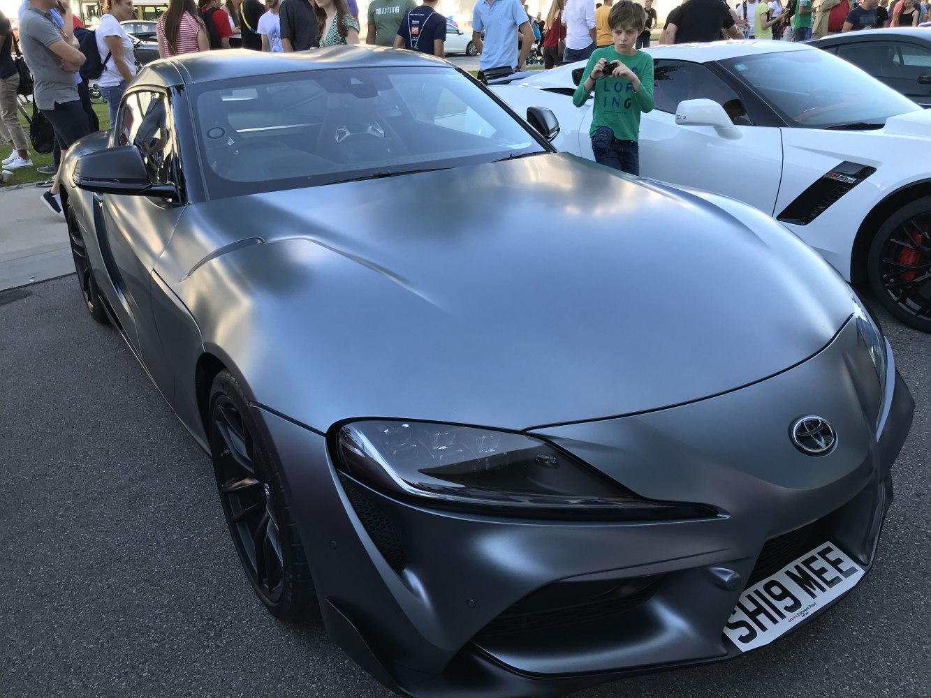 Matte grey sports coupe with sleek LED headlights and aerodynamic design
