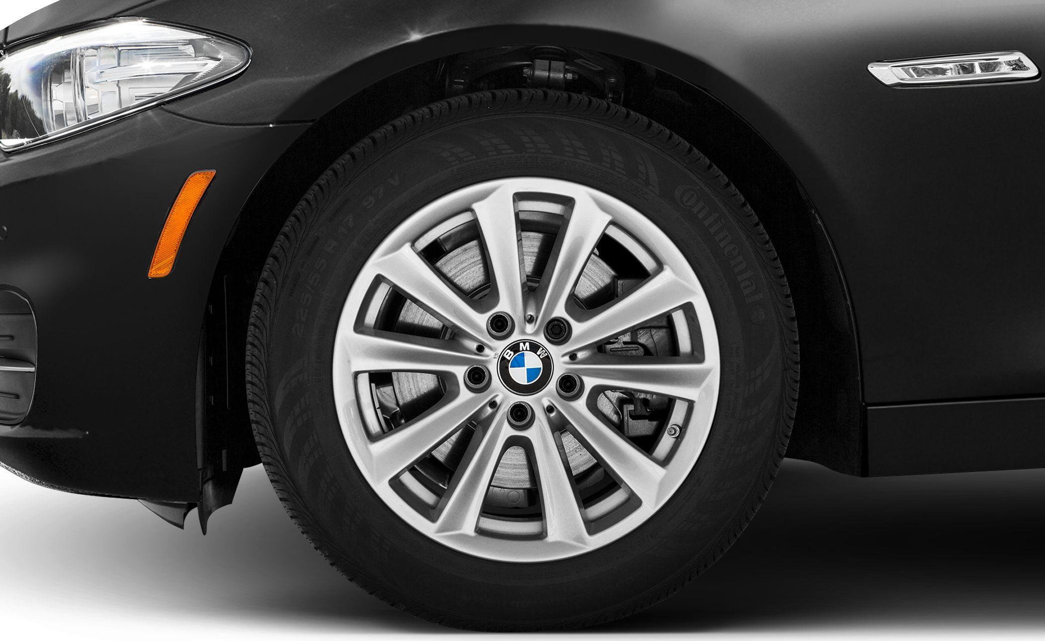 Close-up of alloy wheel, fender, indicator lights on a vehicle.