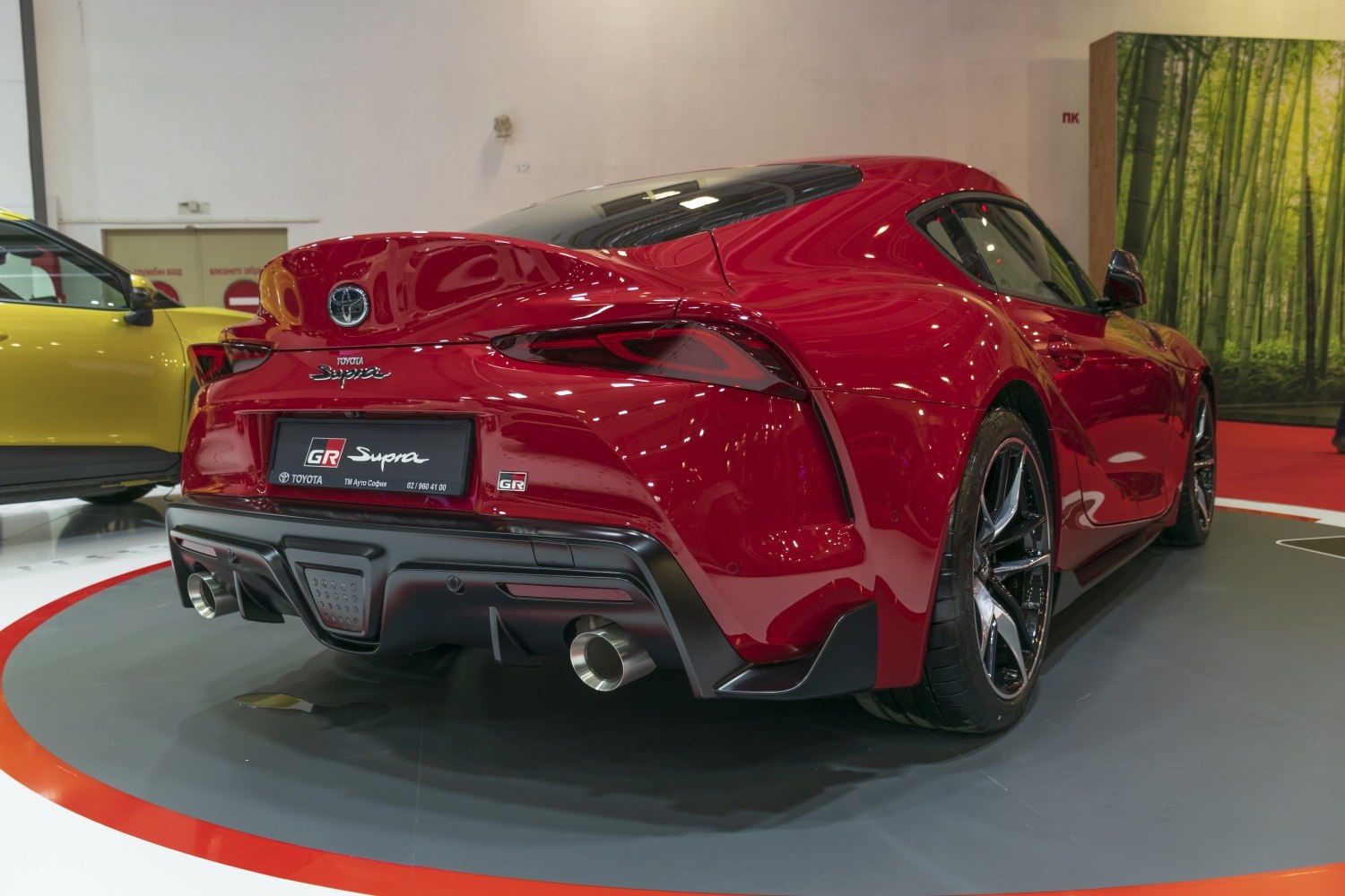 Red sports car rear with twin exhaust and aerodynamic design