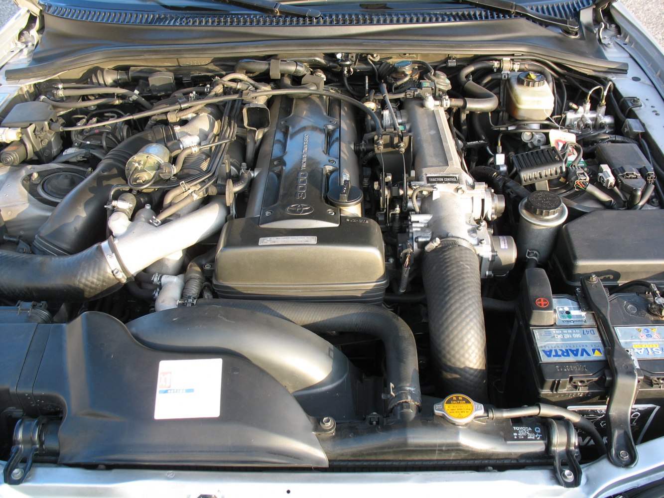 Detailed view of inline 6 engine with turbo and engine bay components