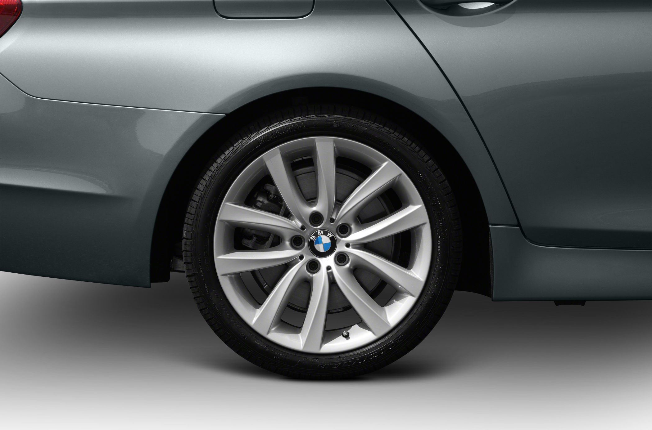 Close-up of alloy wheel and rear fender on a sedan.