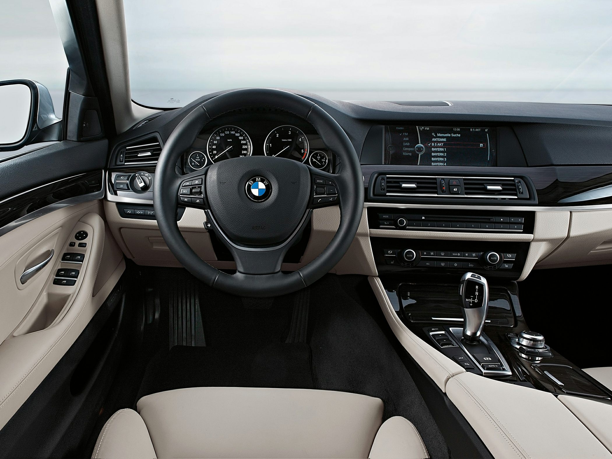 Interior dashboard, steering wheel, and central console with gear shifter