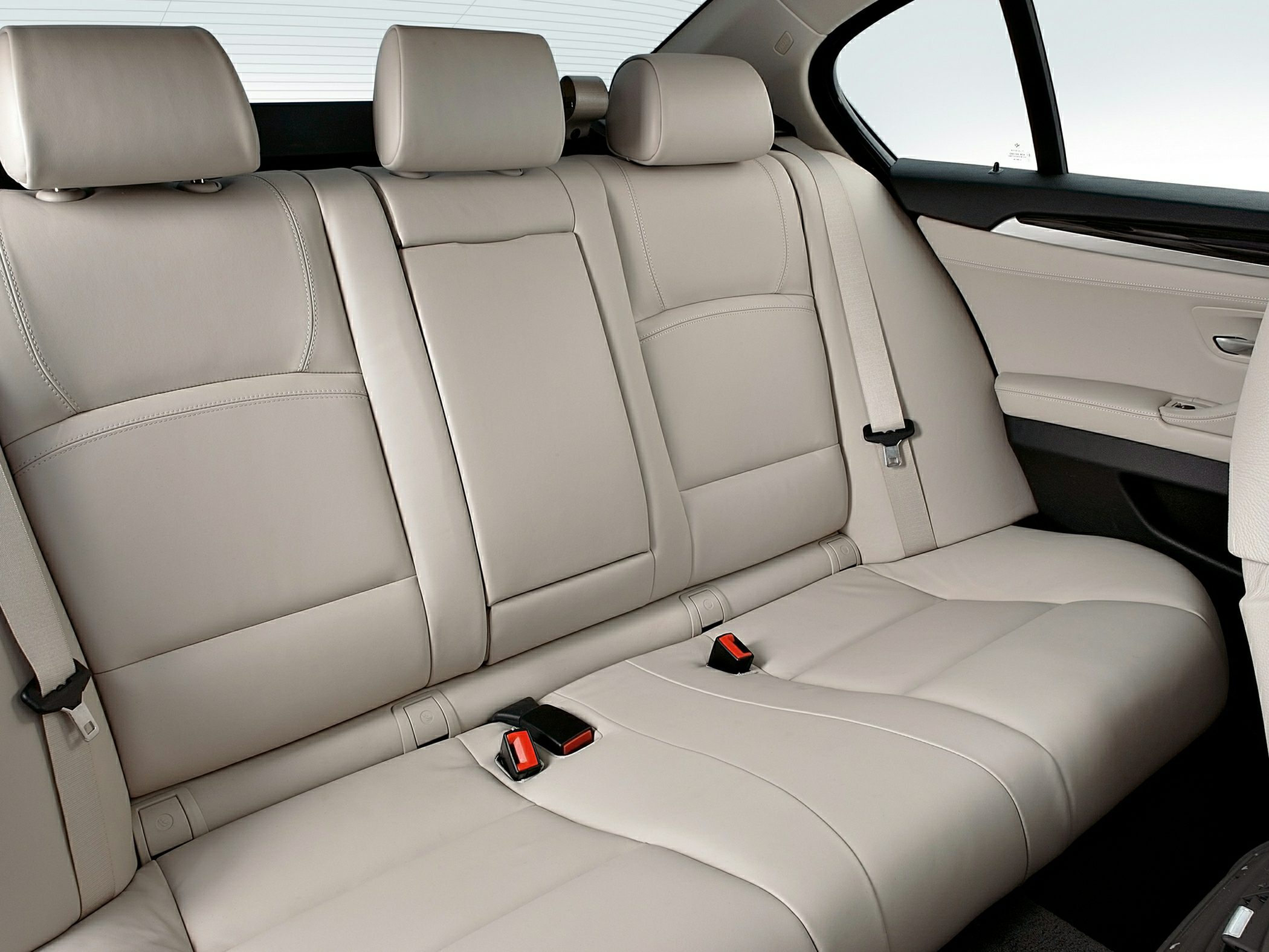 Beige leather rear seats with headrests and seat belts
