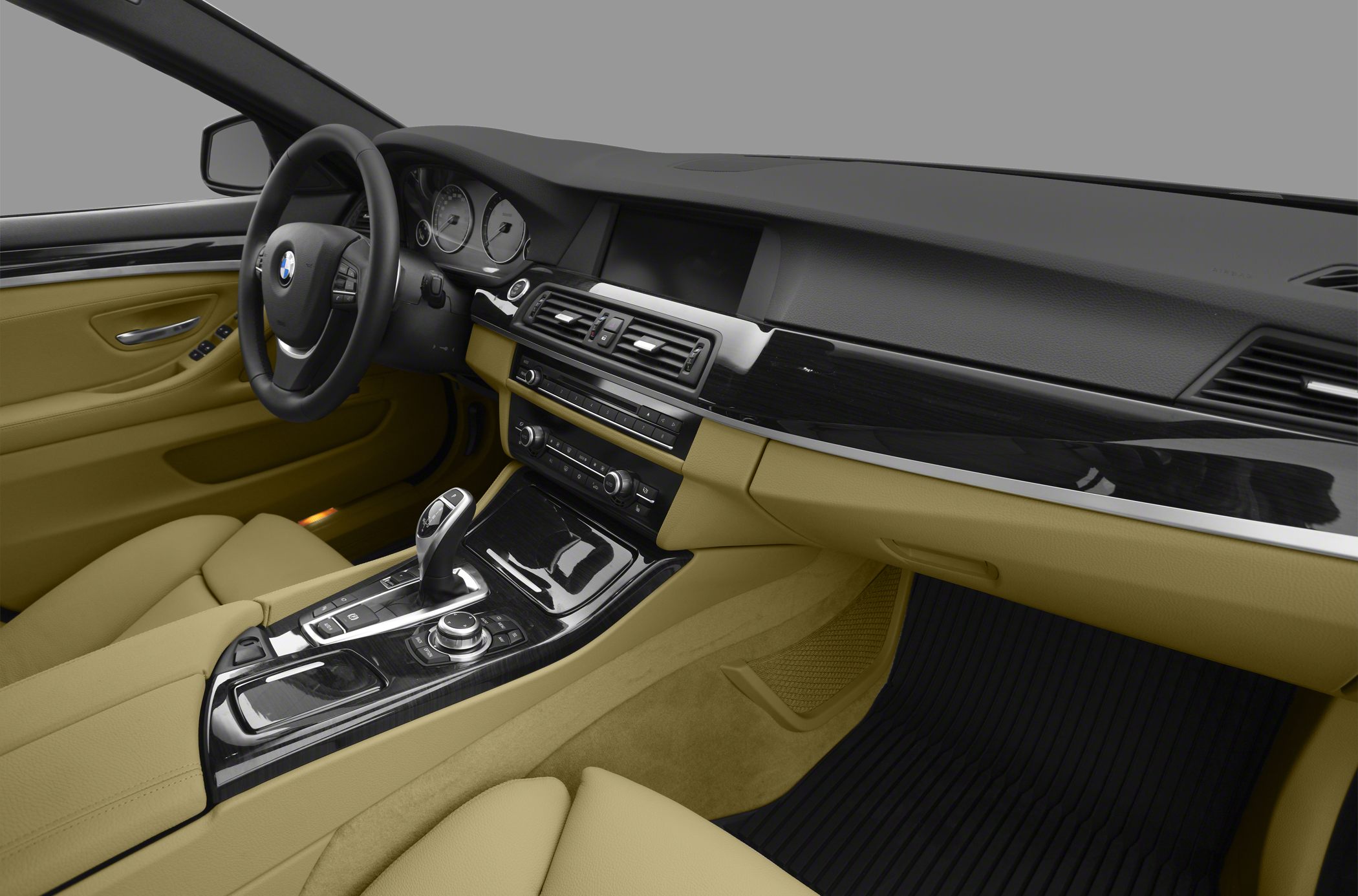 Dashboard and center console with gear shift and beige leather seats