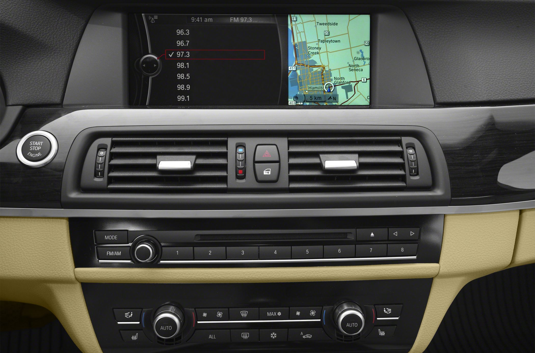 Dashboard with navigation screen and dual-zone climate control knobs