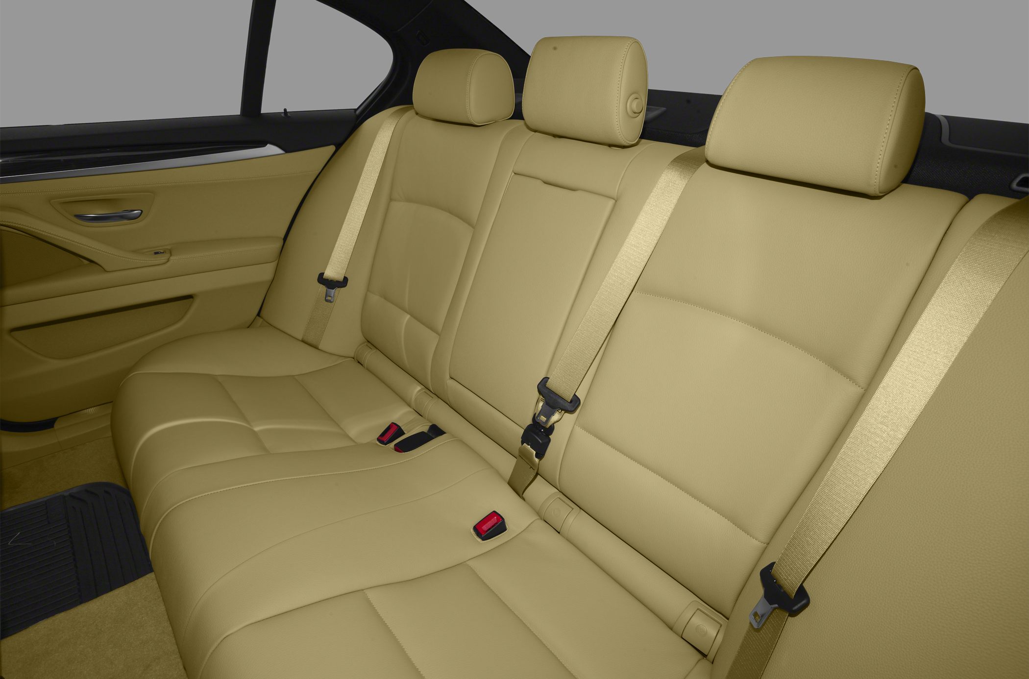 Beige leather rear seats with headrests and seat belts