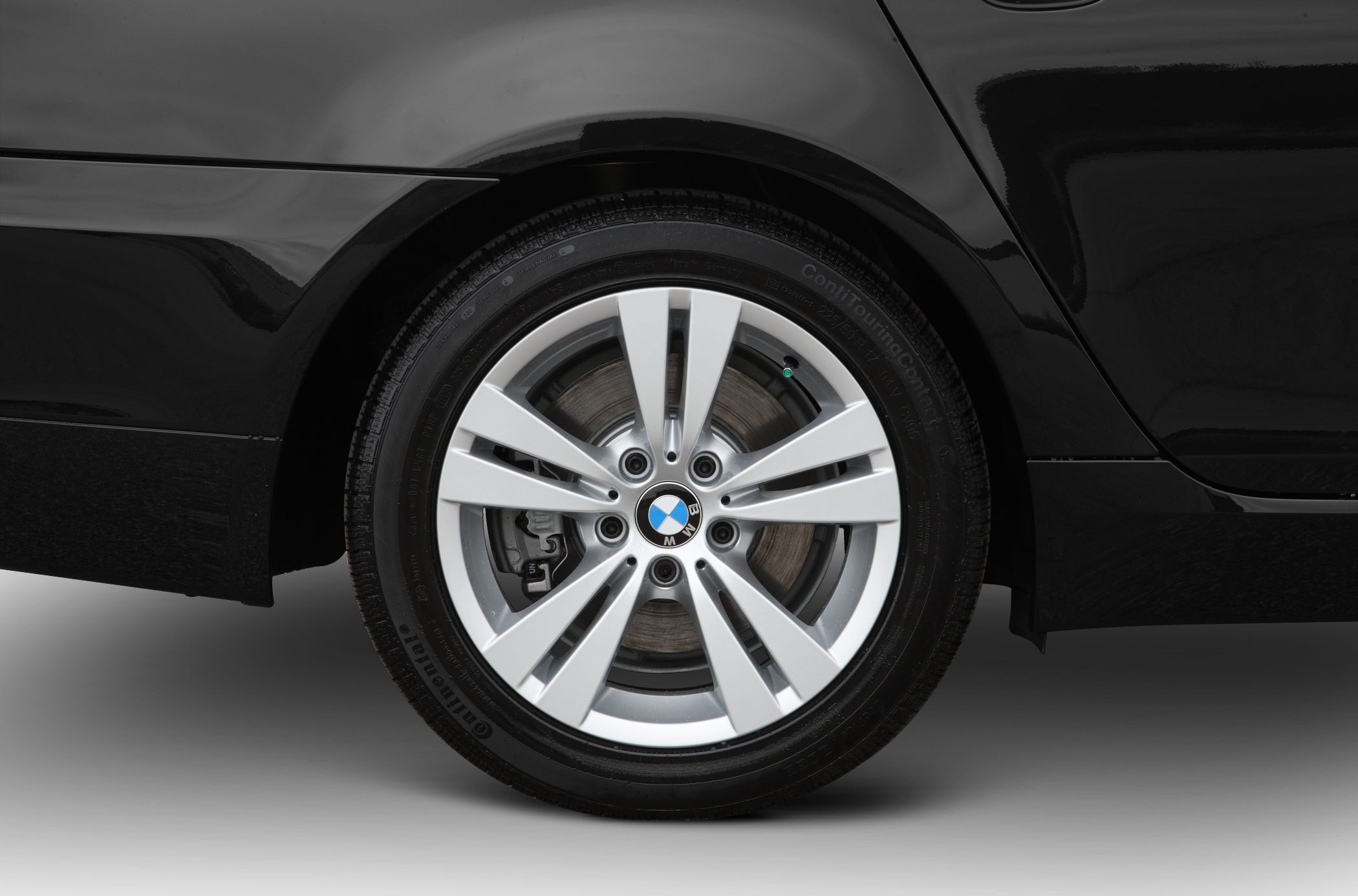 Alloy wheel and brake disc close-up with Continental tire
