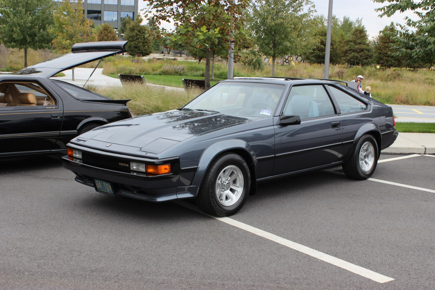 Pop-up headlights and alloy wheels on a sleek 1980s sports coupe