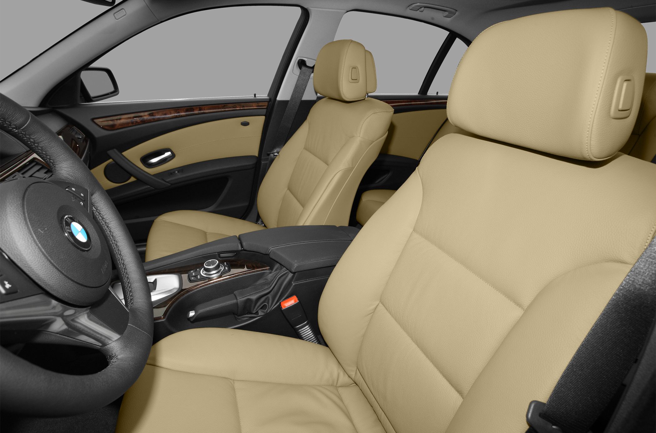 Beige leather seats with wood trim and steering wheel in luxury car interior