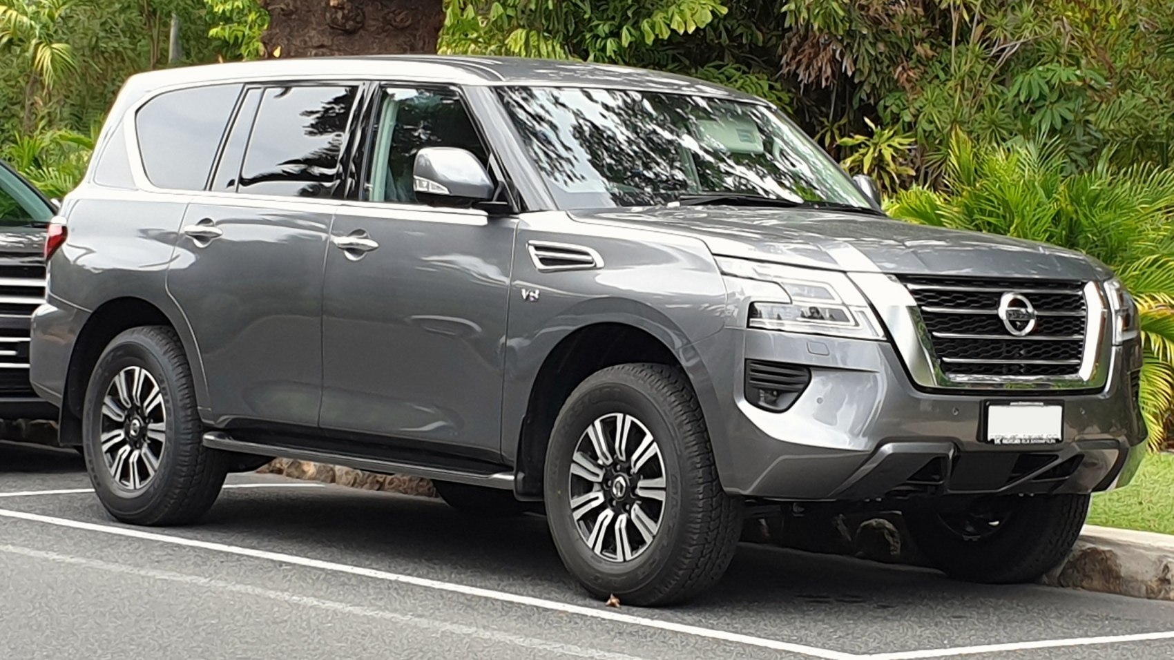 Front side view of a modern SUV with alloy wheels and chrome grille.