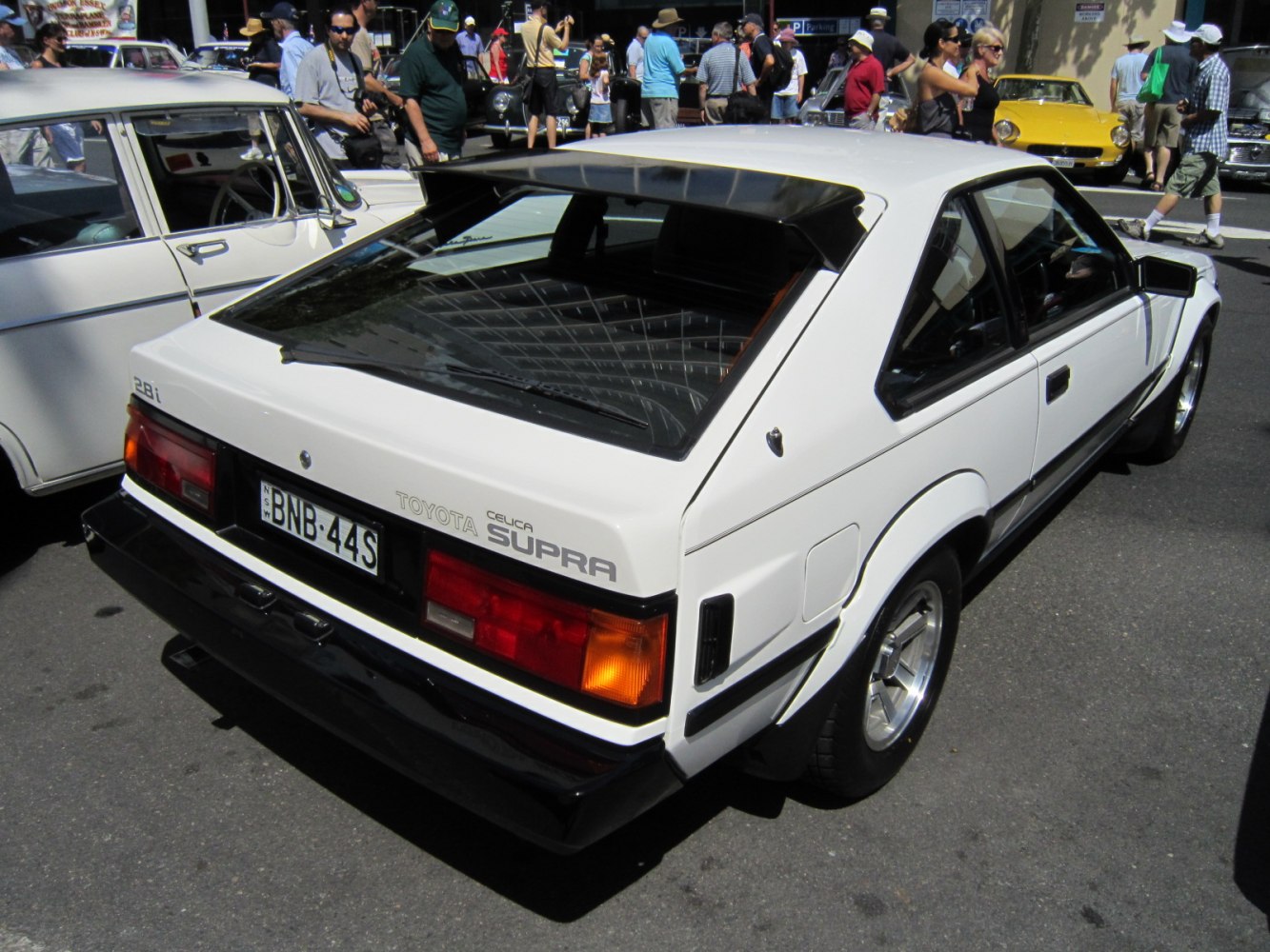 Rear view of a classic 1981 white hatchback sports coupe with distinct angular design.