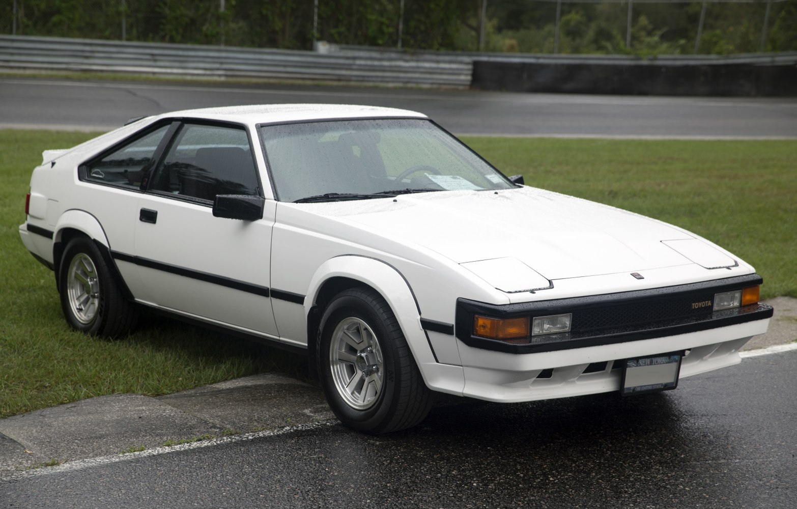 Two-door sports coupe with pop-up headlights and prominent fender flares