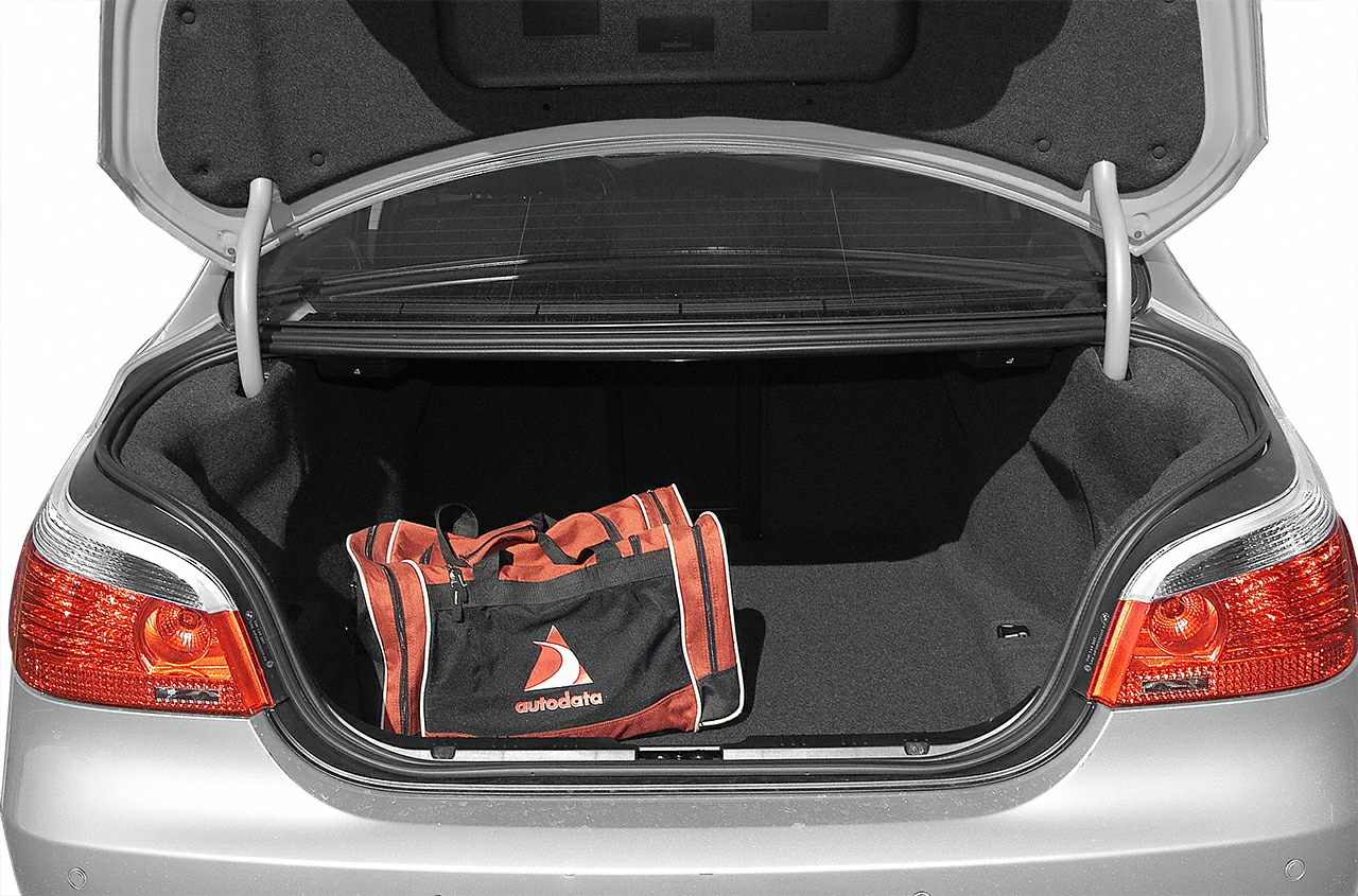 Open sedan trunk with spacious cargo area and duffel bag inside