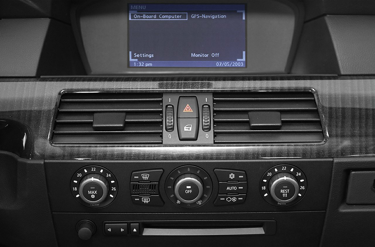 Dashboard climate control dials and on-board computer display.