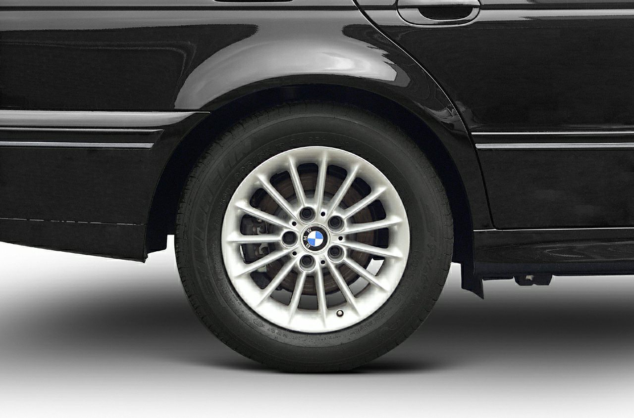 Rear wheel and side panel with alloy wheel on black sedan