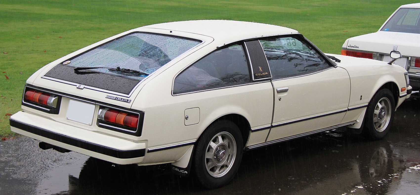 Rear hatch window with wiper and rectangular taillights on vintage coupe