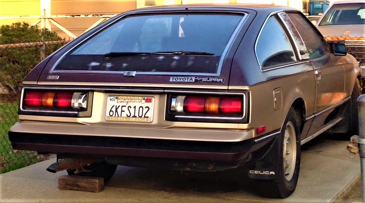 Rear view with distinctive tail lights and hatchback design