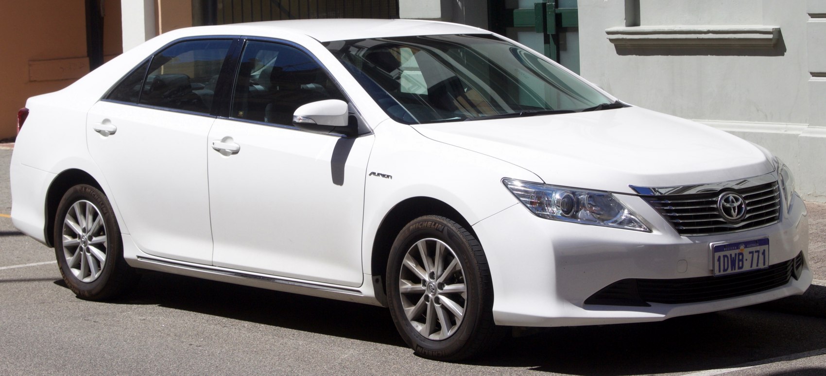 White sedan showing front and side with alloy wheels