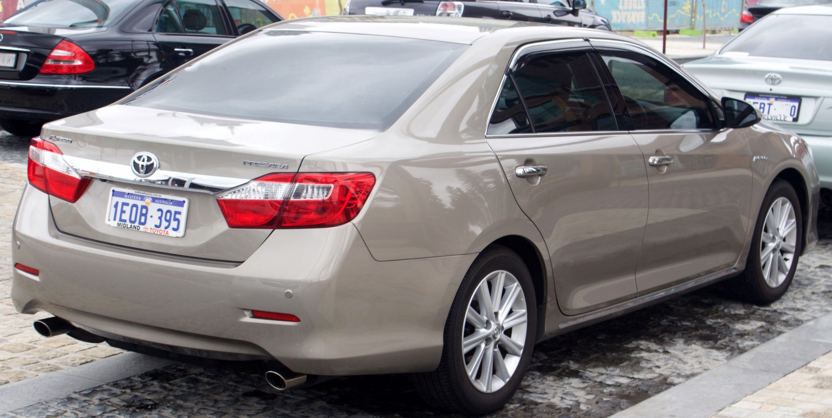 Rear view of mid-size sedan with distinctive tail lights and dual exhaust