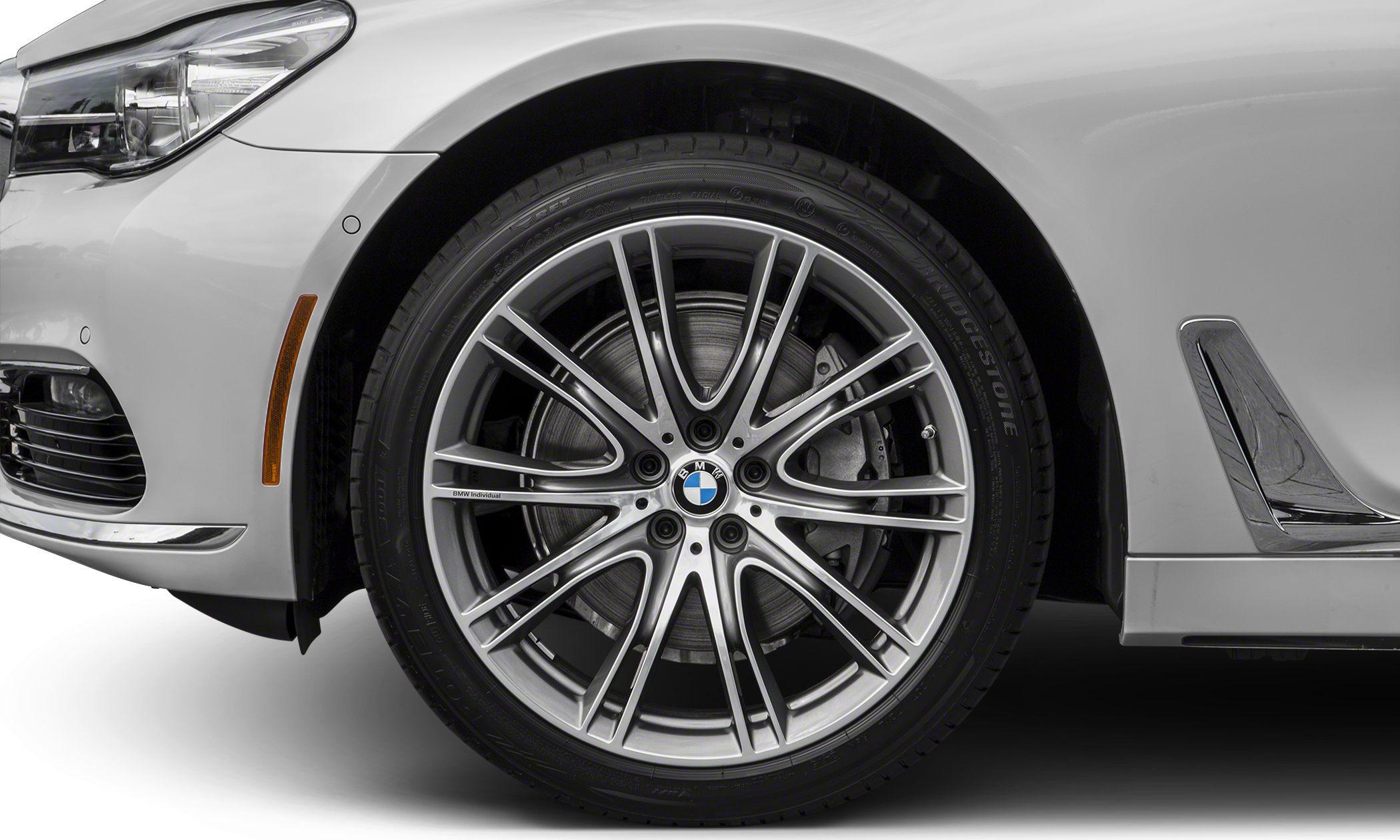 Close-up of alloy wheel and front fender with headlight and chrome trim