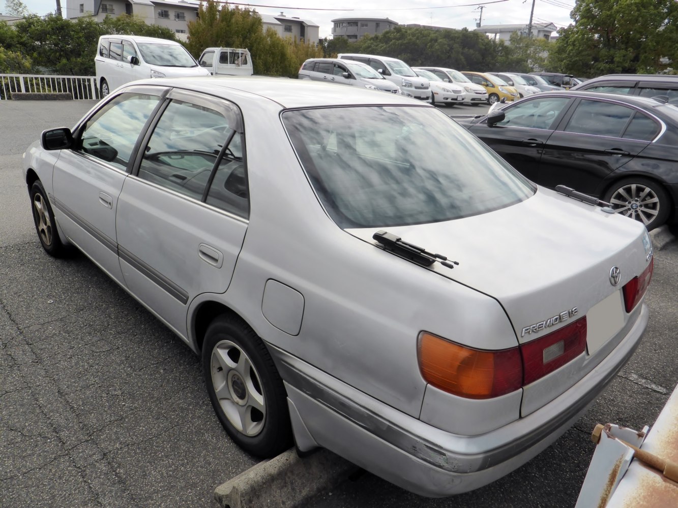 Rear and side perspective of a sedan with classic taillights and rear wiper