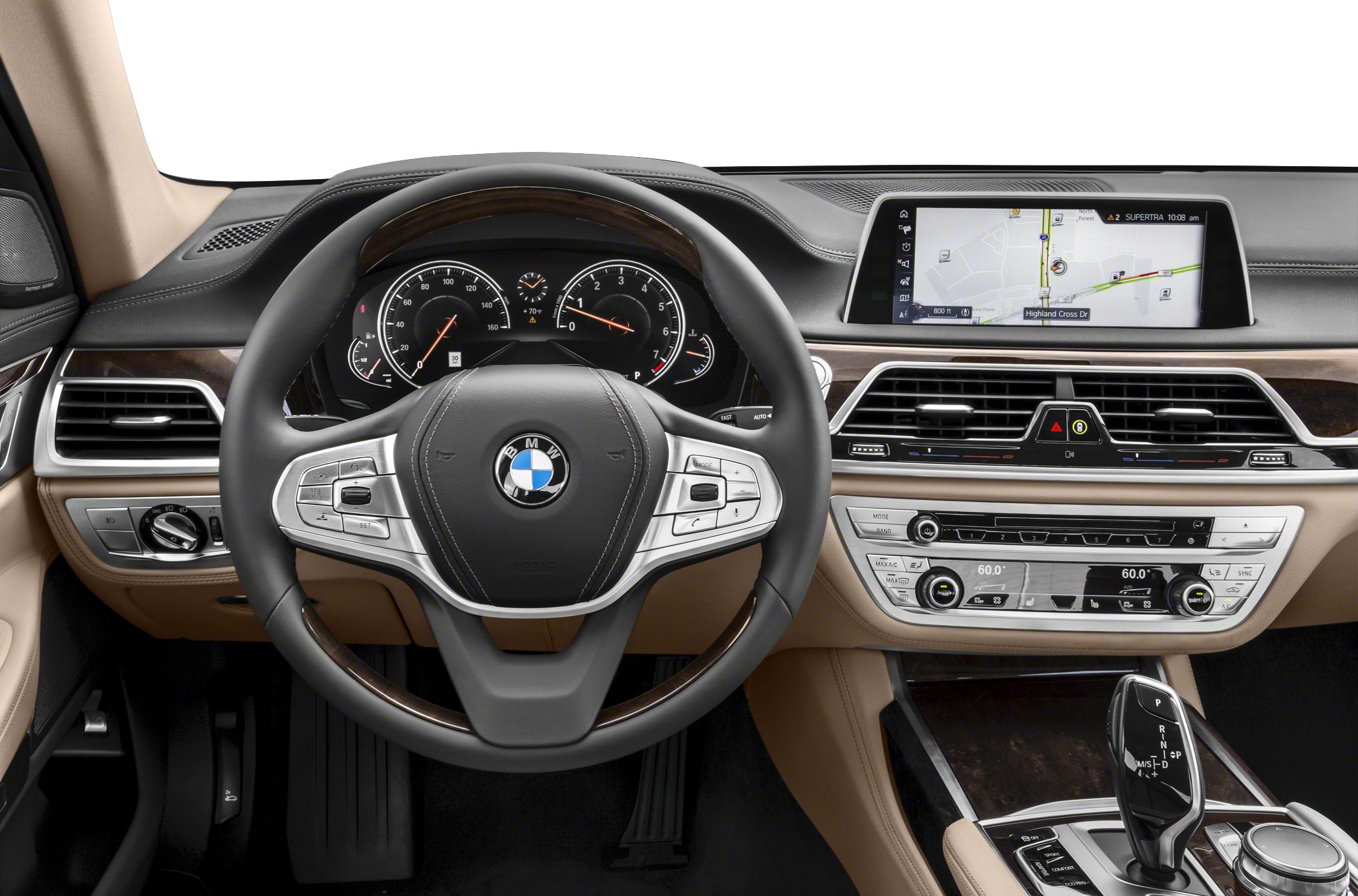 Steering wheel, analog gauges, and infotainment screen of luxury car interior