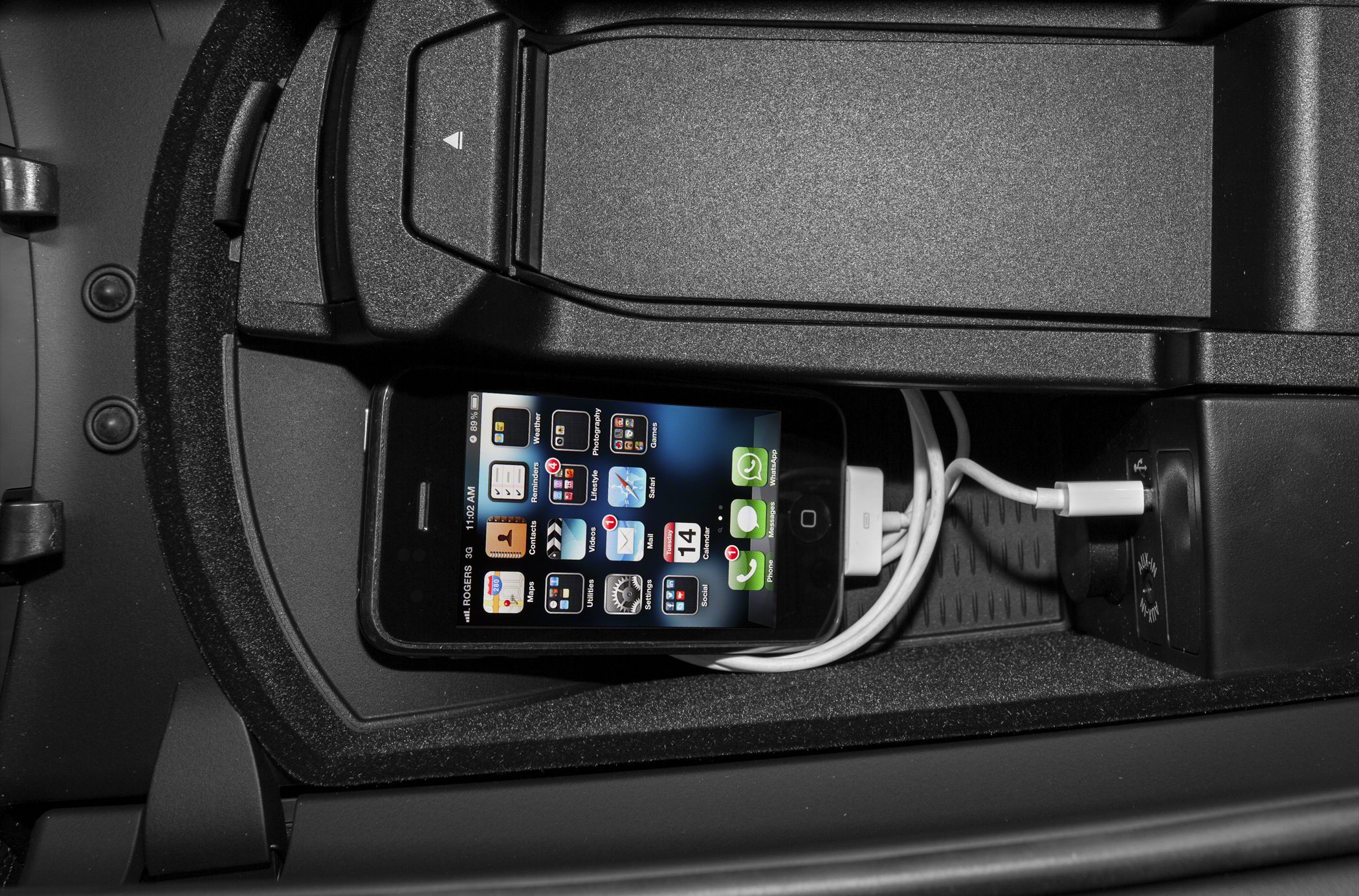Center console with phone holder and charging cable.