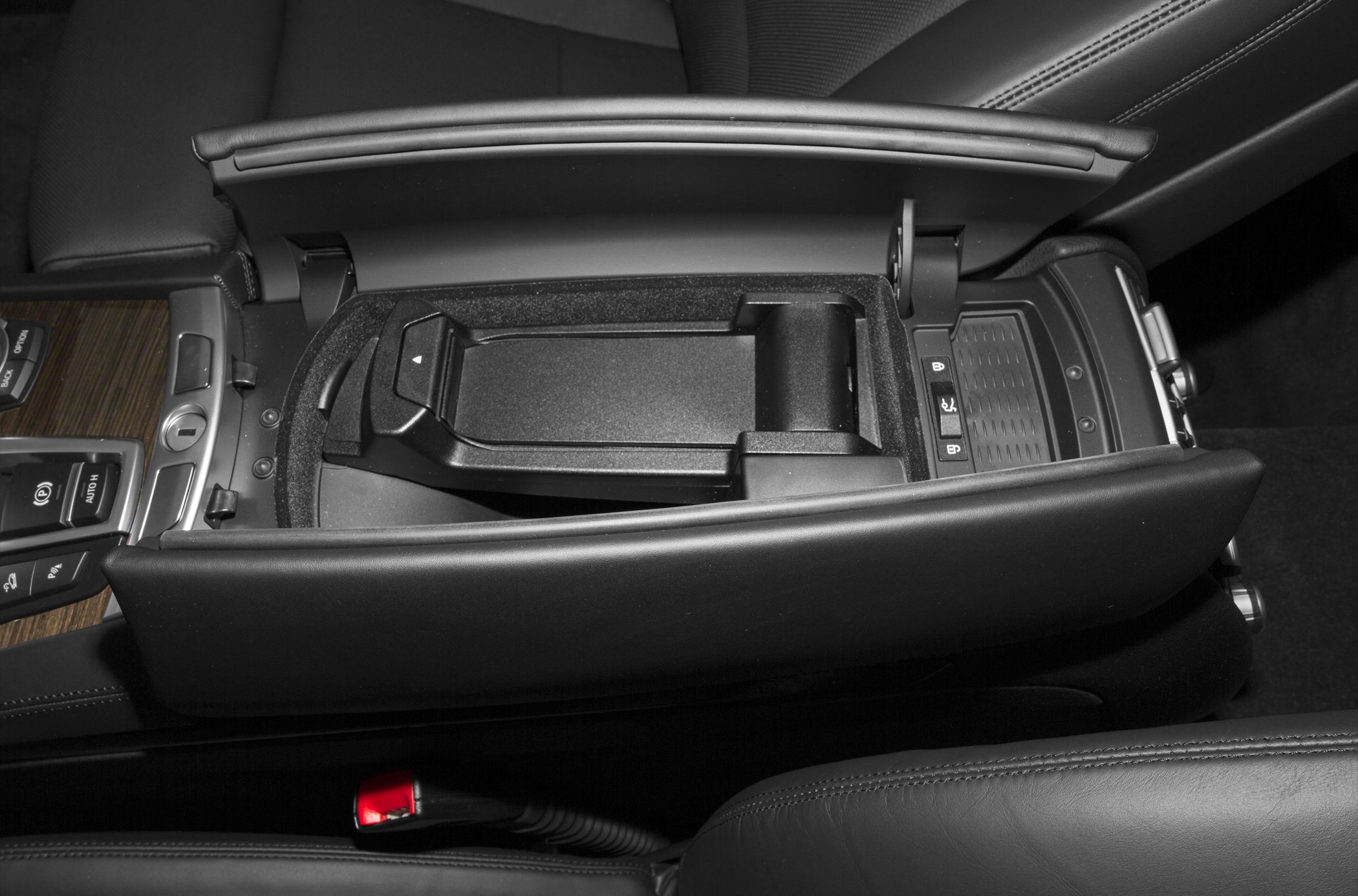 Center console storage compartment with armrest and control buttons
