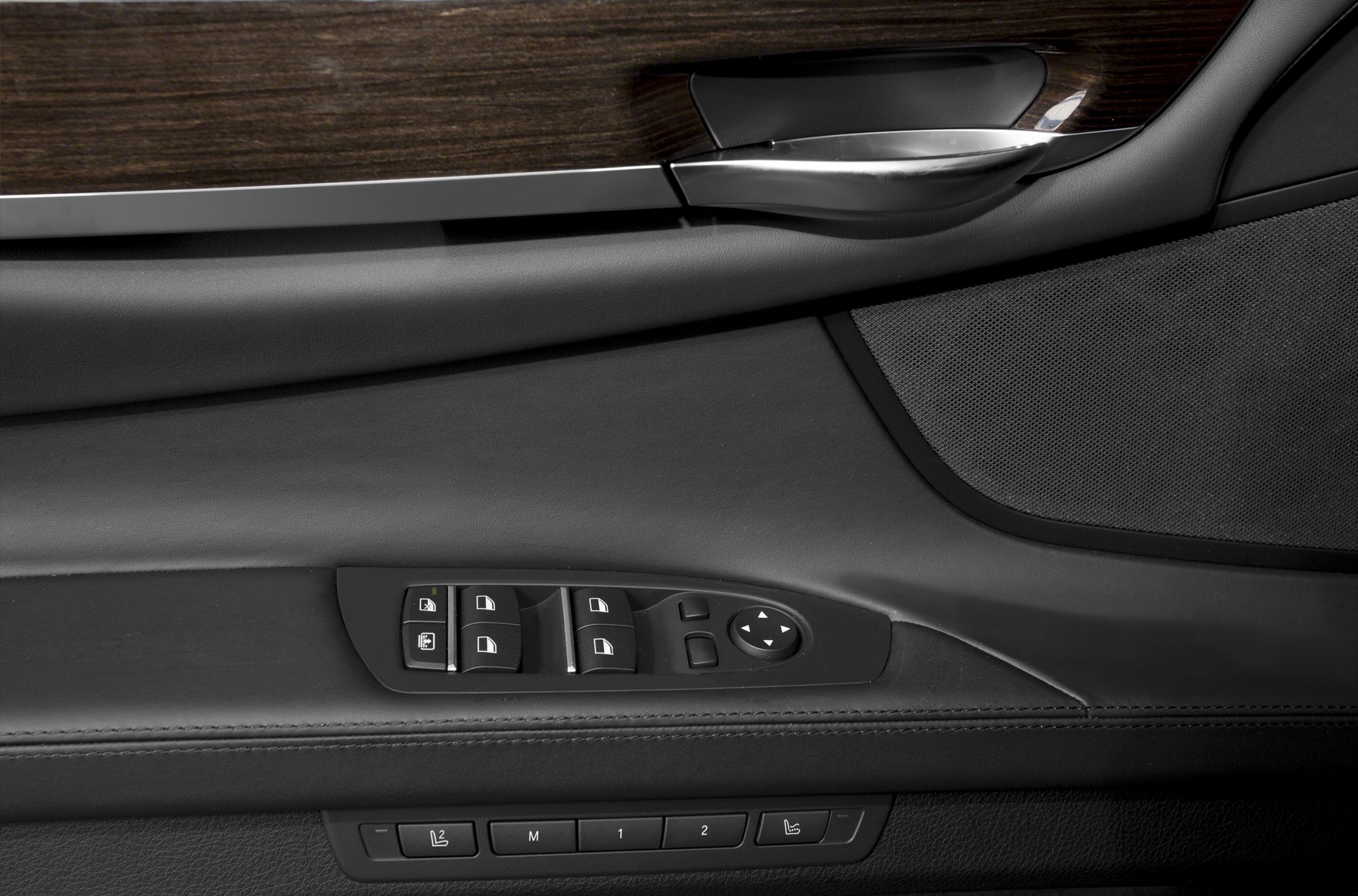 Luxury car door panel with window and seat memory controls