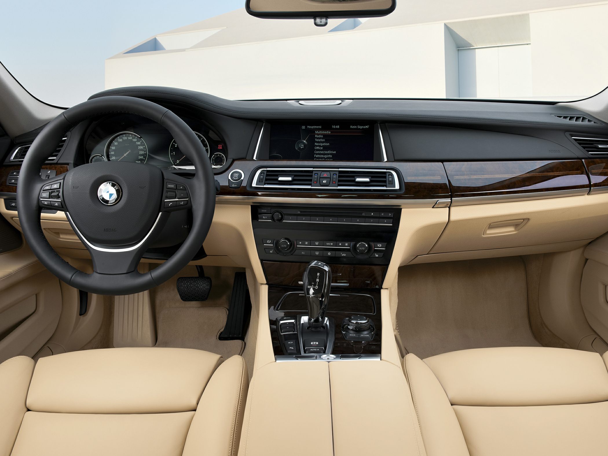 Luxury interior with wood trim, leather seats, and advanced dashboard controls