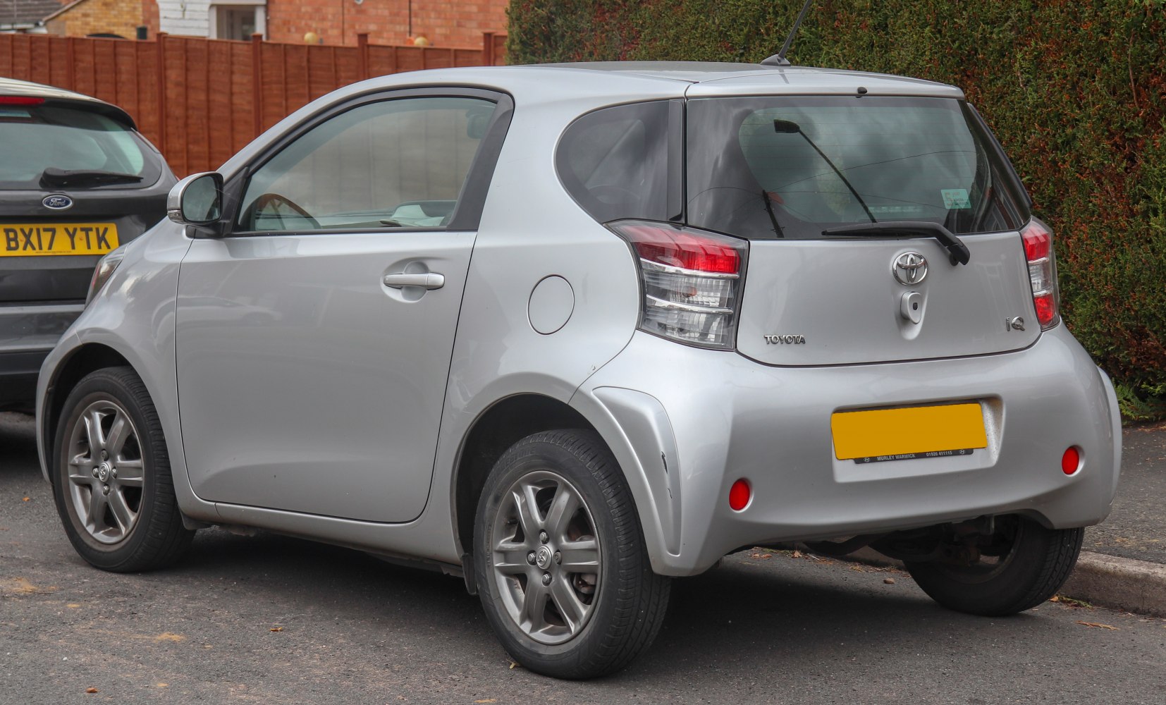 Rear three-quarter view of a compact hatchback with distinctive taillights and silver paint