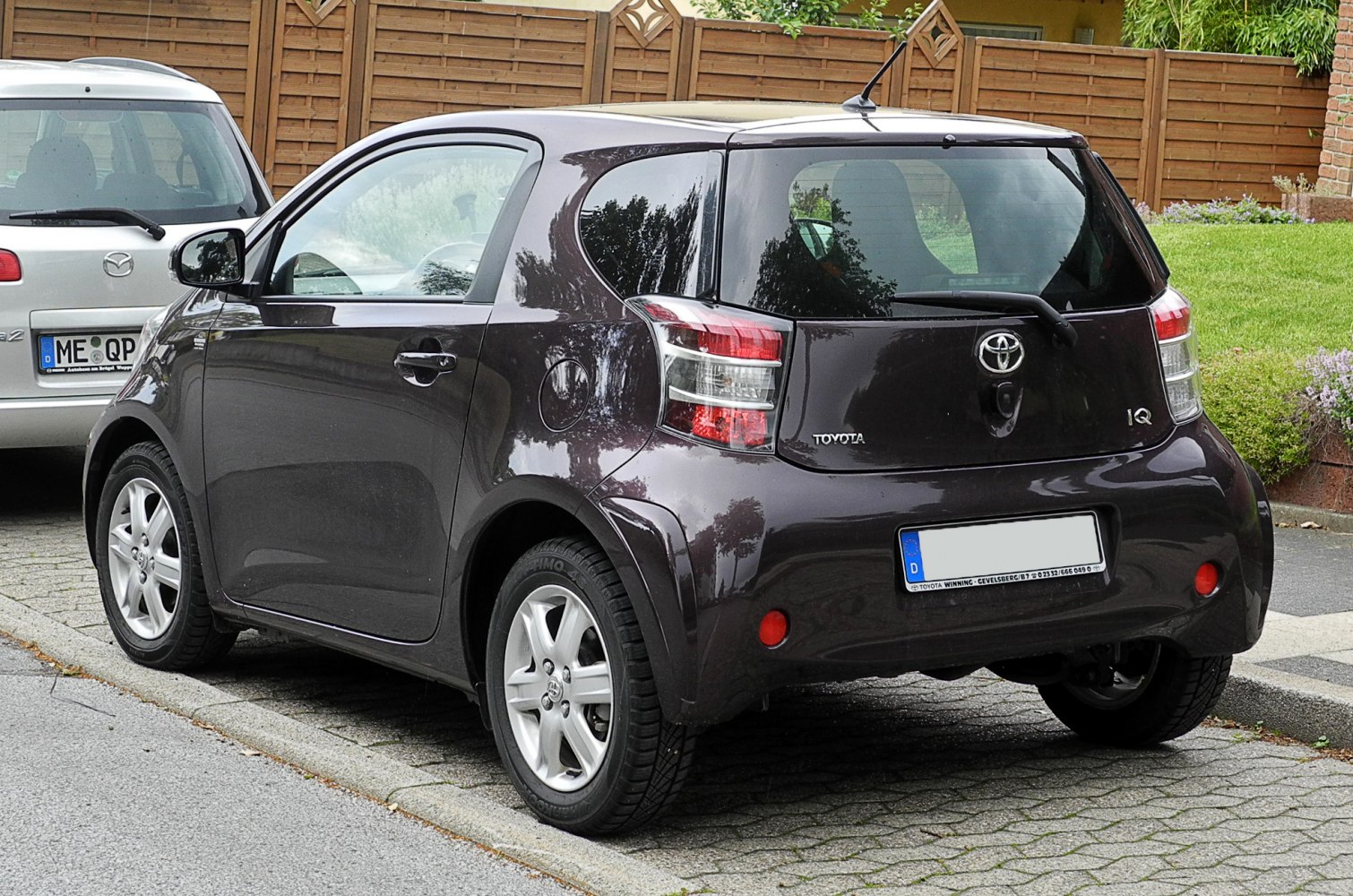 Compact hatchback rear view with distinctive taillights and rear wiper