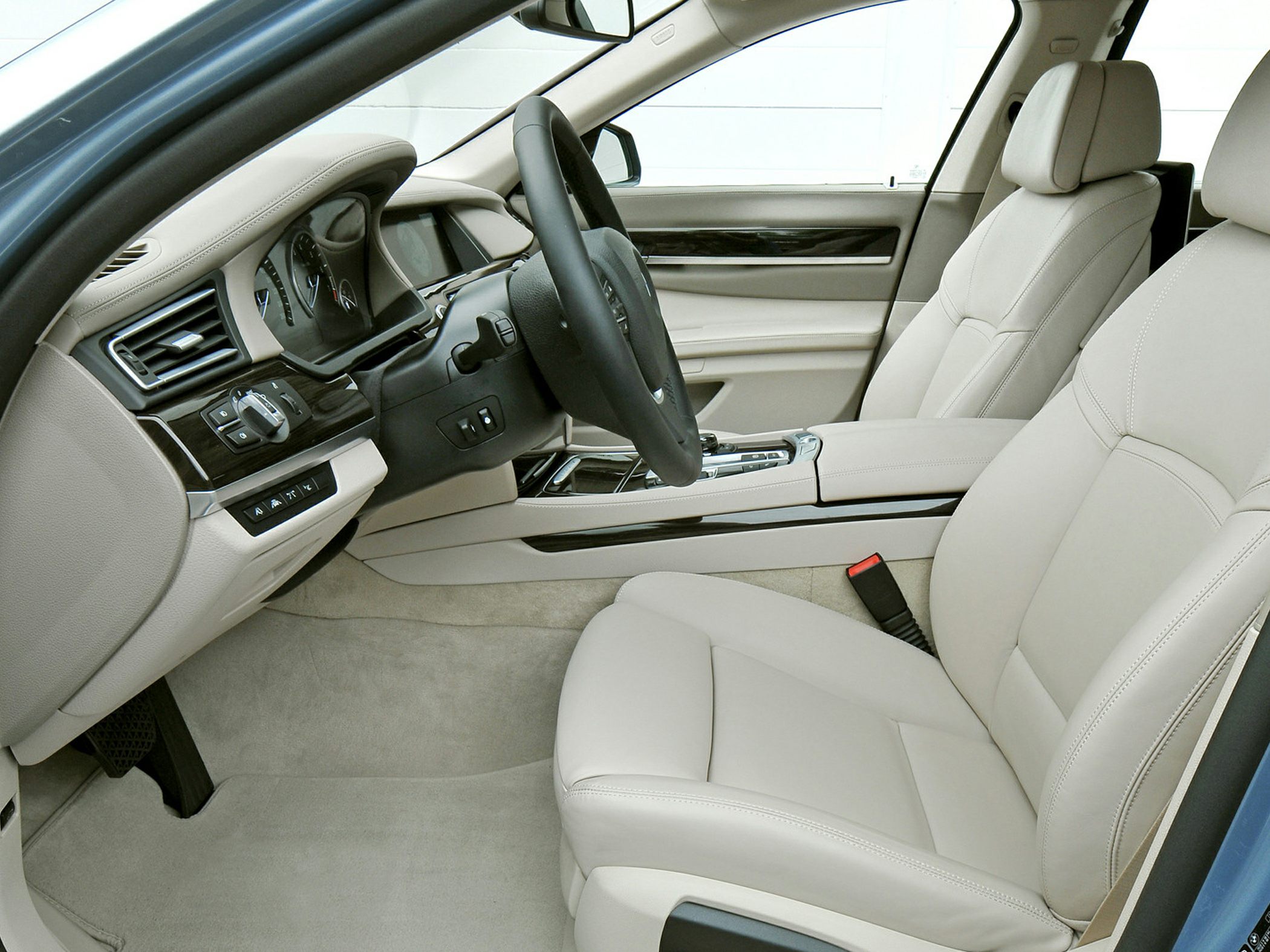 Beige leather seats with advanced dashboard and modern steering wheel