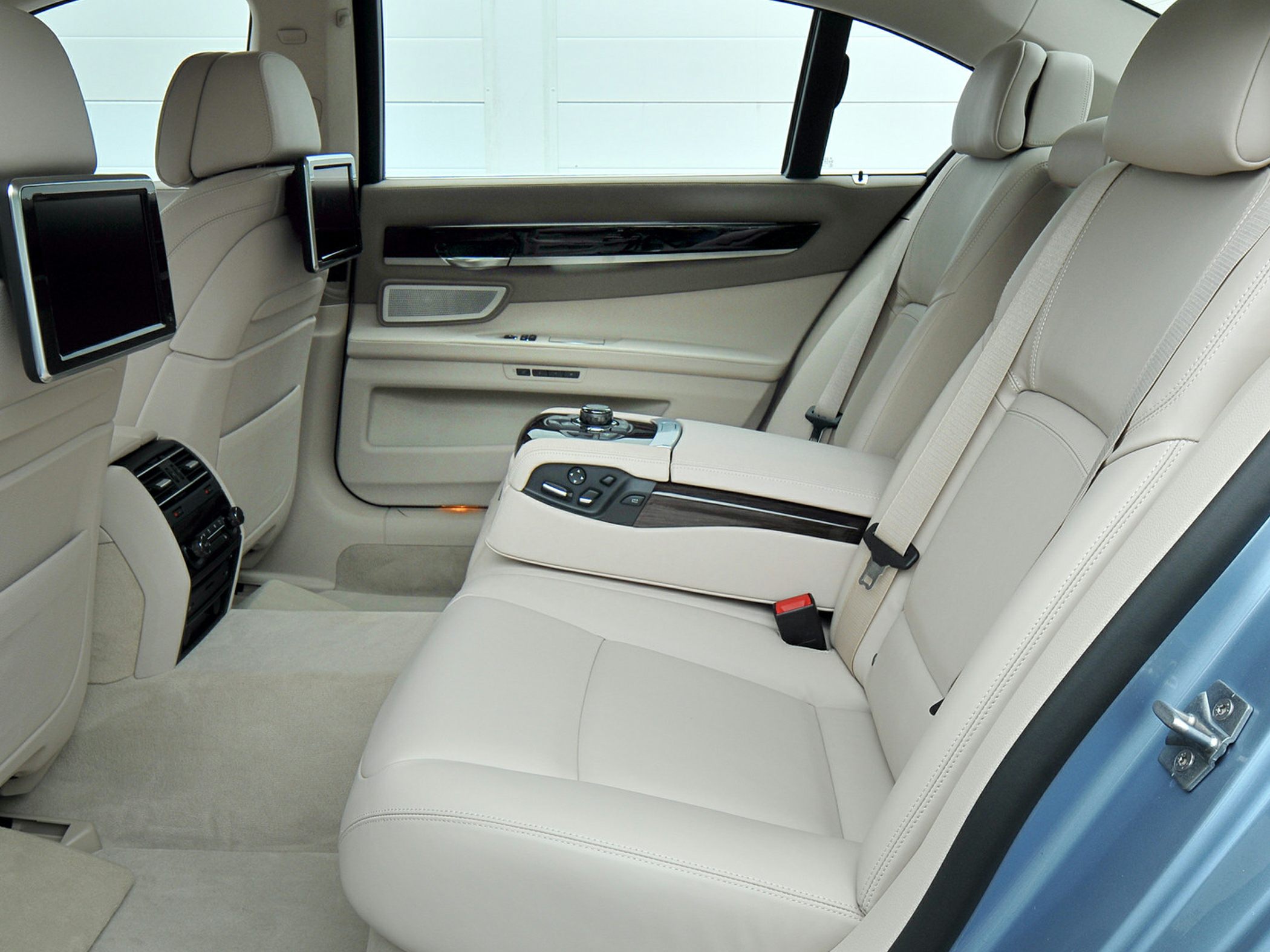 Beige leather rear seats with entertainment screens and control console