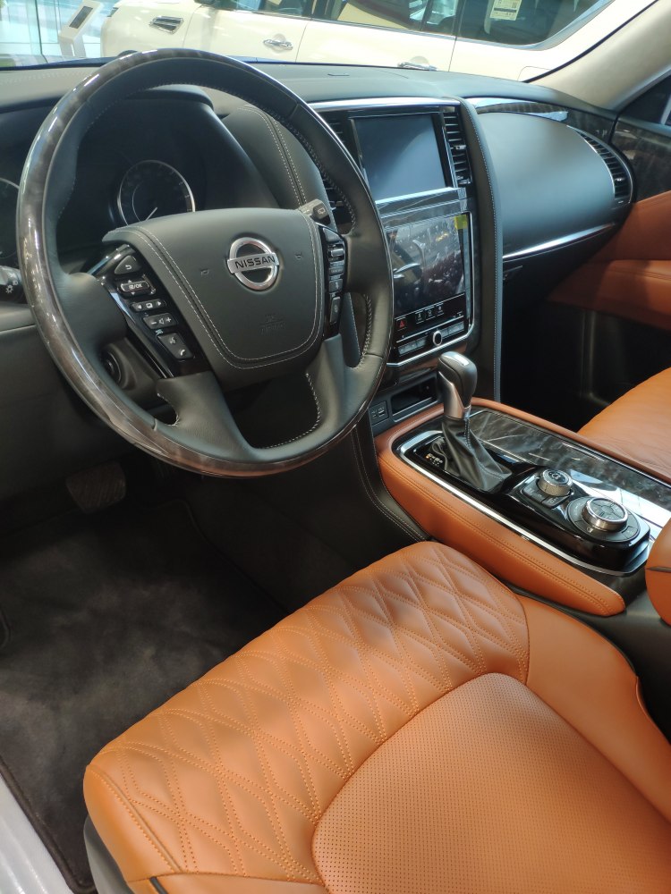 Luxury car interior with stitched leather seats and advanced center control panel