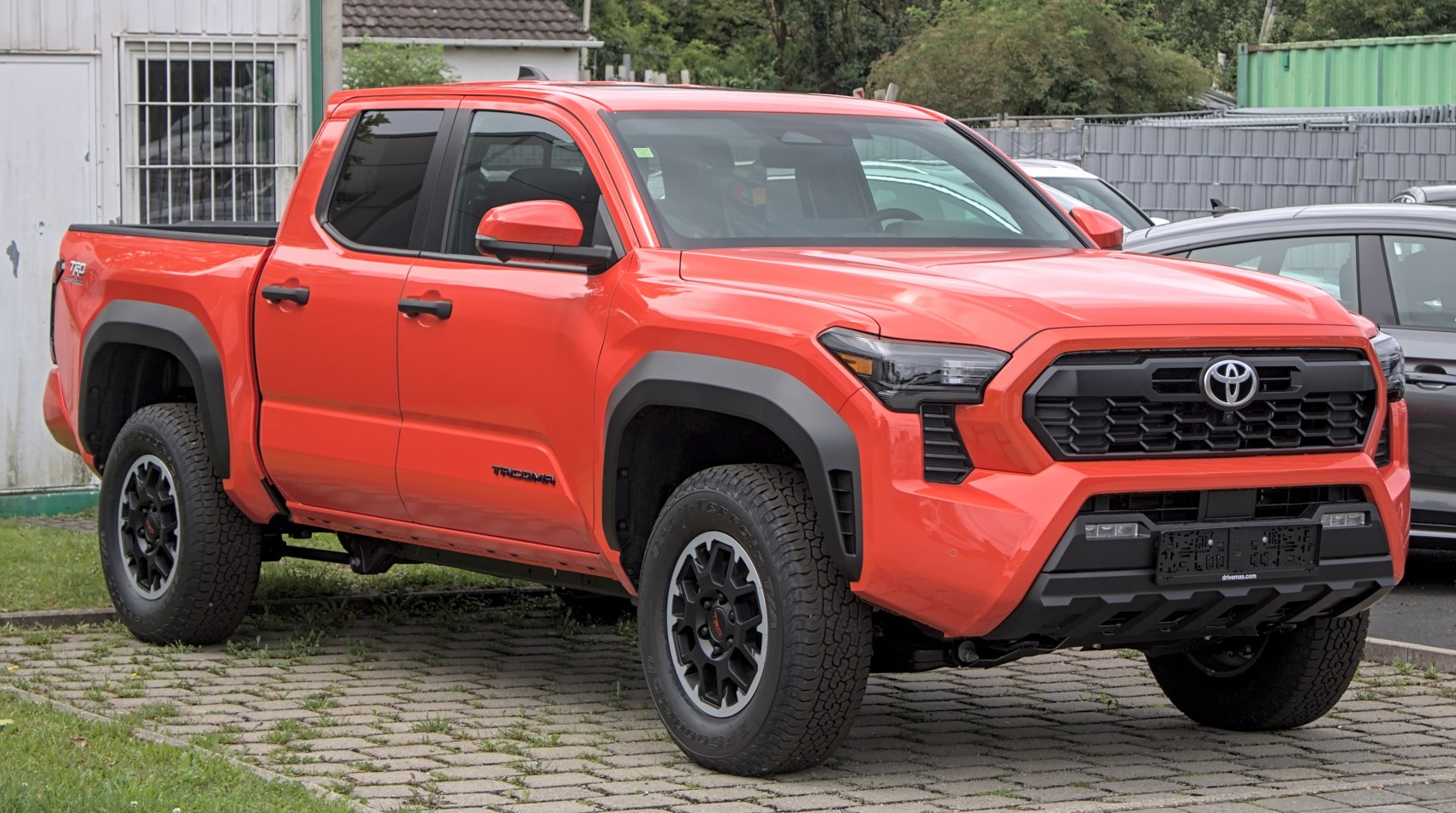 Mid-size pickup with bold black grille and offroad wheels