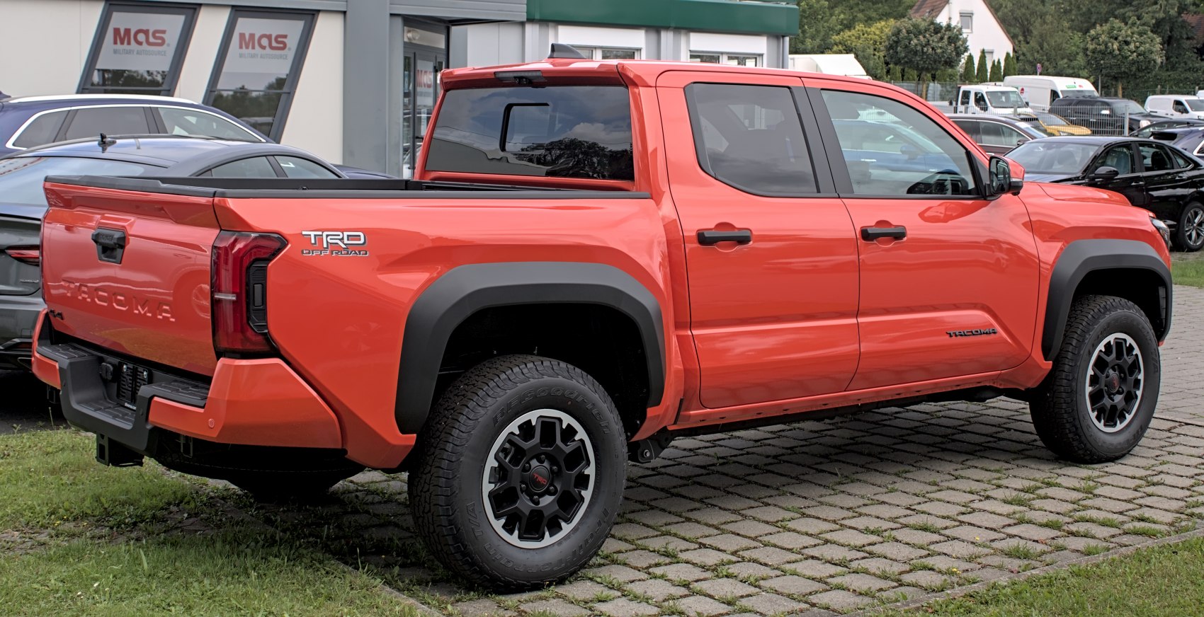 Bright orange pickup truck with TRD Off Road badge and double cab design