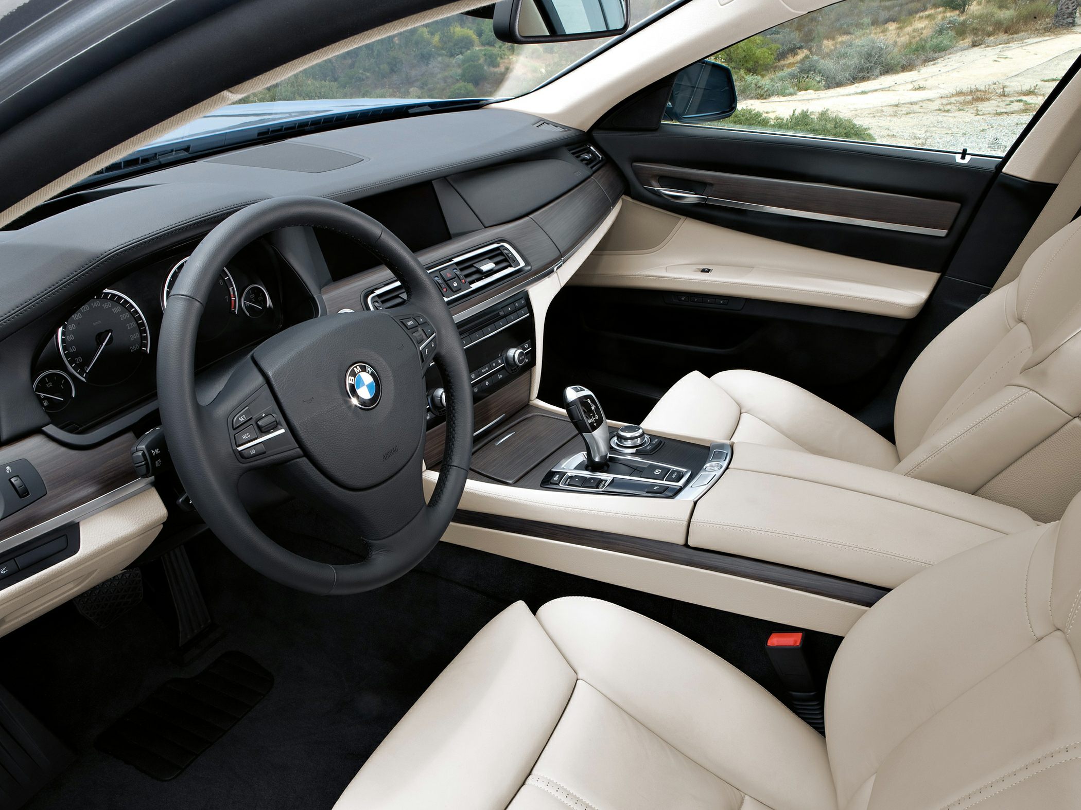 Beige leather seats with wood-trimmed dashboard and modern controls