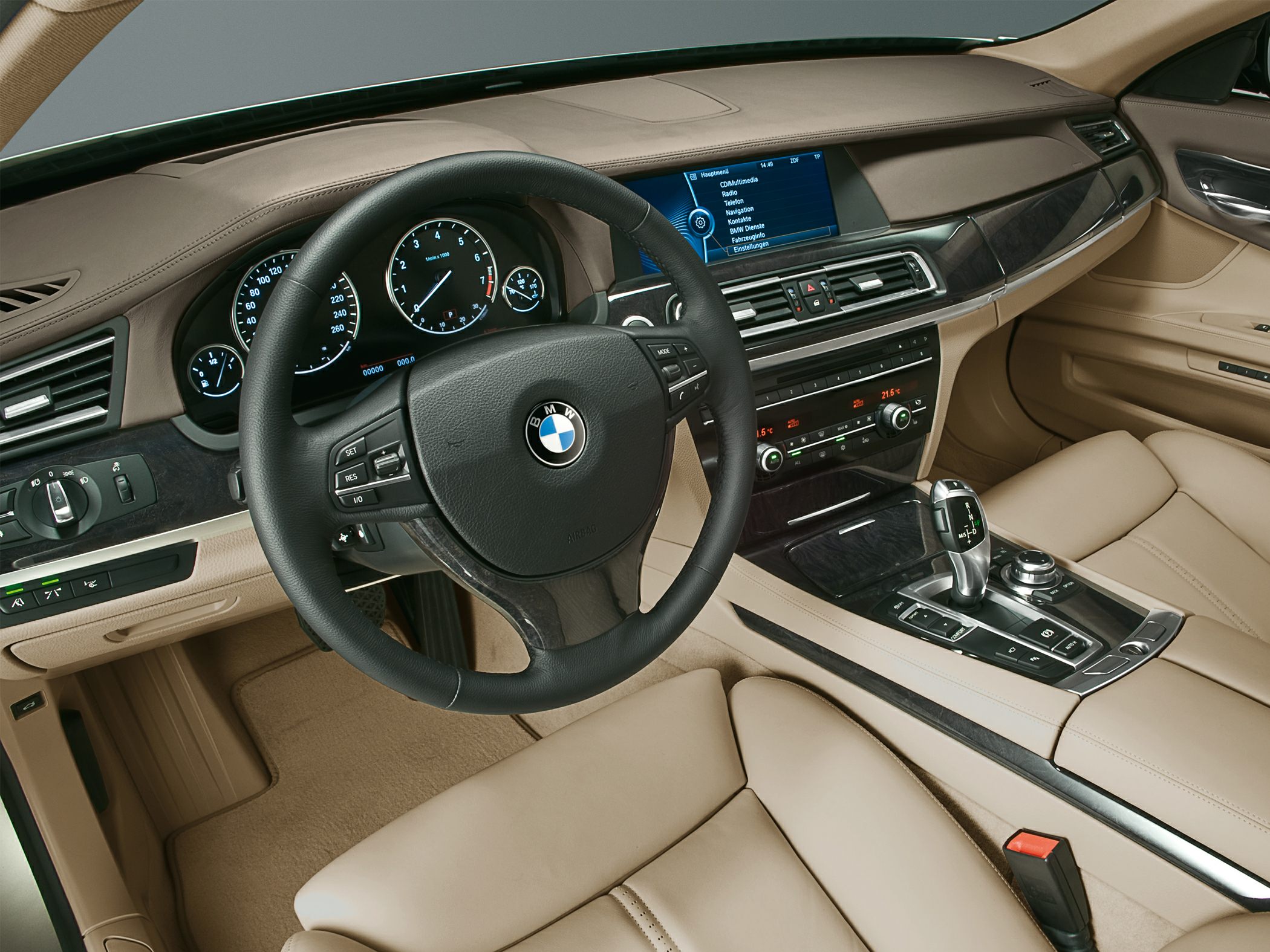 Luxury beige interior with steering wheel, dashboard, and infotainment system
