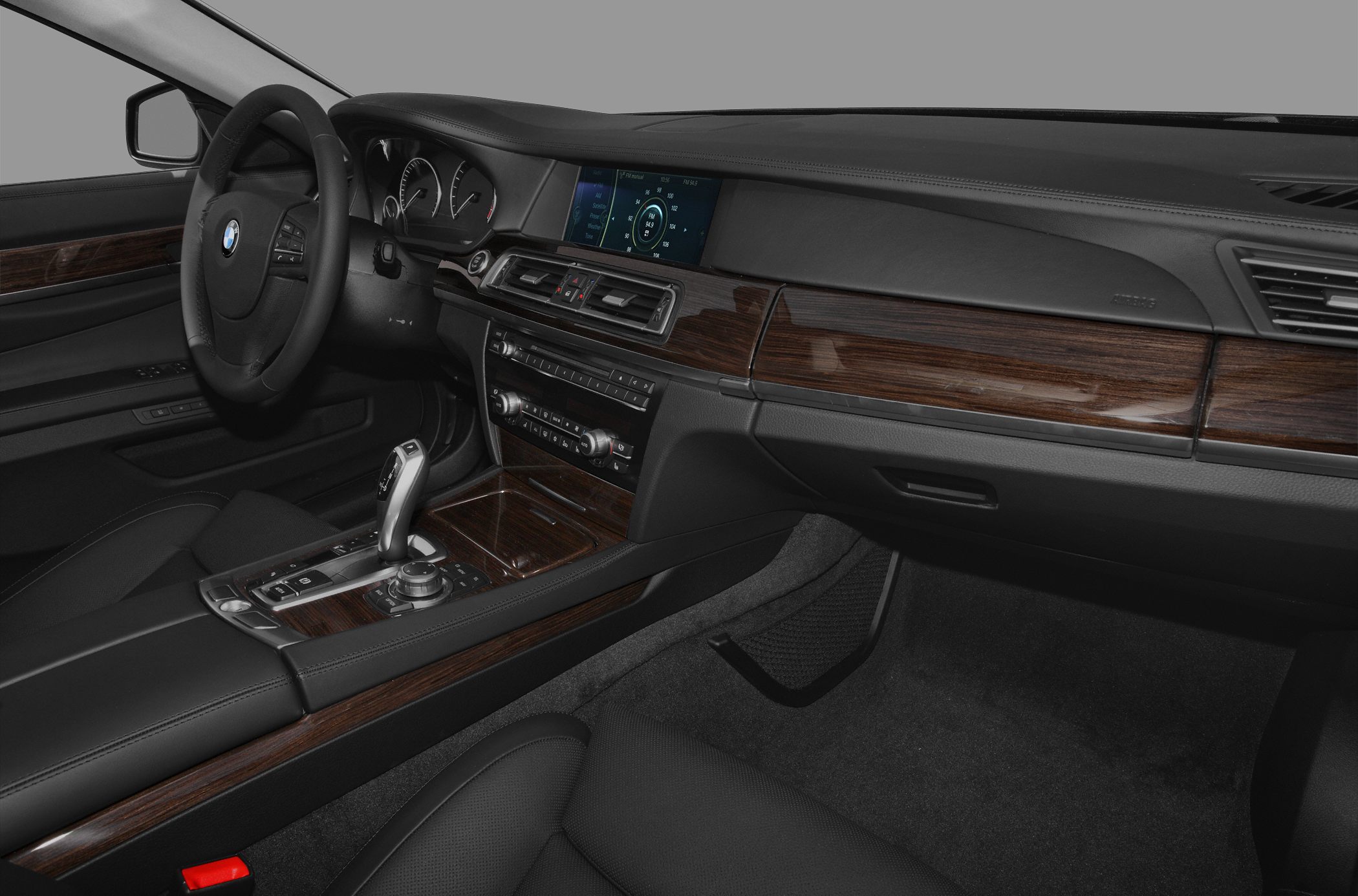 Luxury car interior with wood trim and modern control console