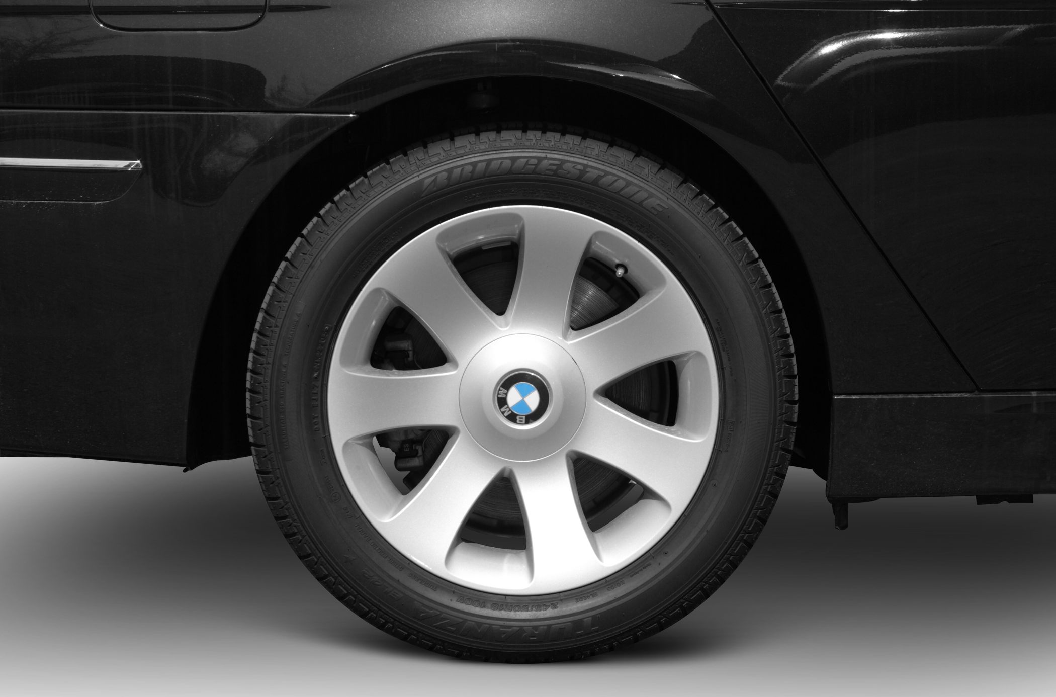 Close-up of alloy wheel and tire on luxury sedan.