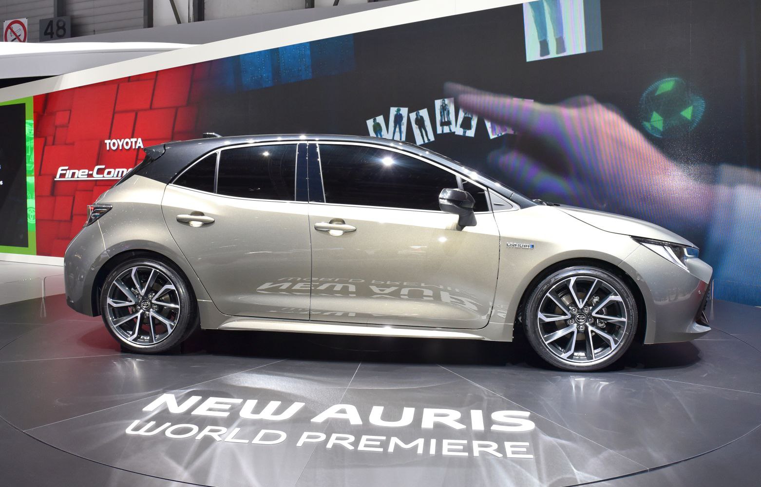 Side profile of a hatchback with sporty alloy wheels and tinted windows