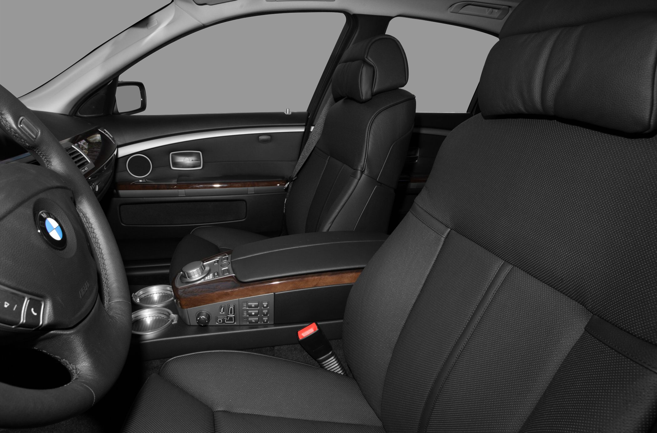 Luxury black leather seats with wood trim center console and modern controls