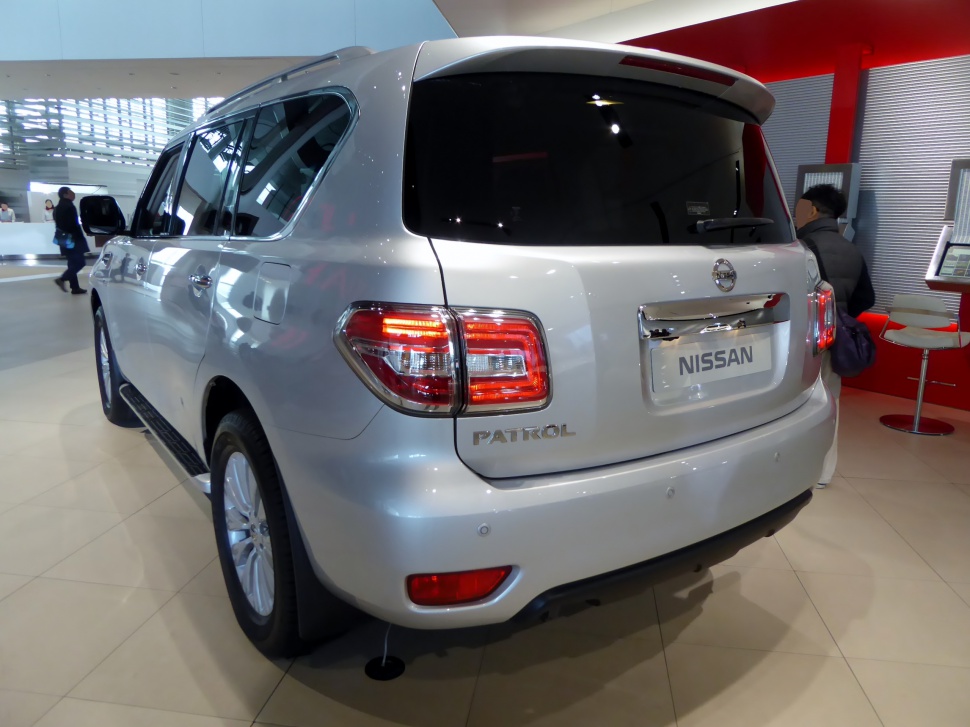 Rear view of large SUV with distinctive taillights and tinted rear windows