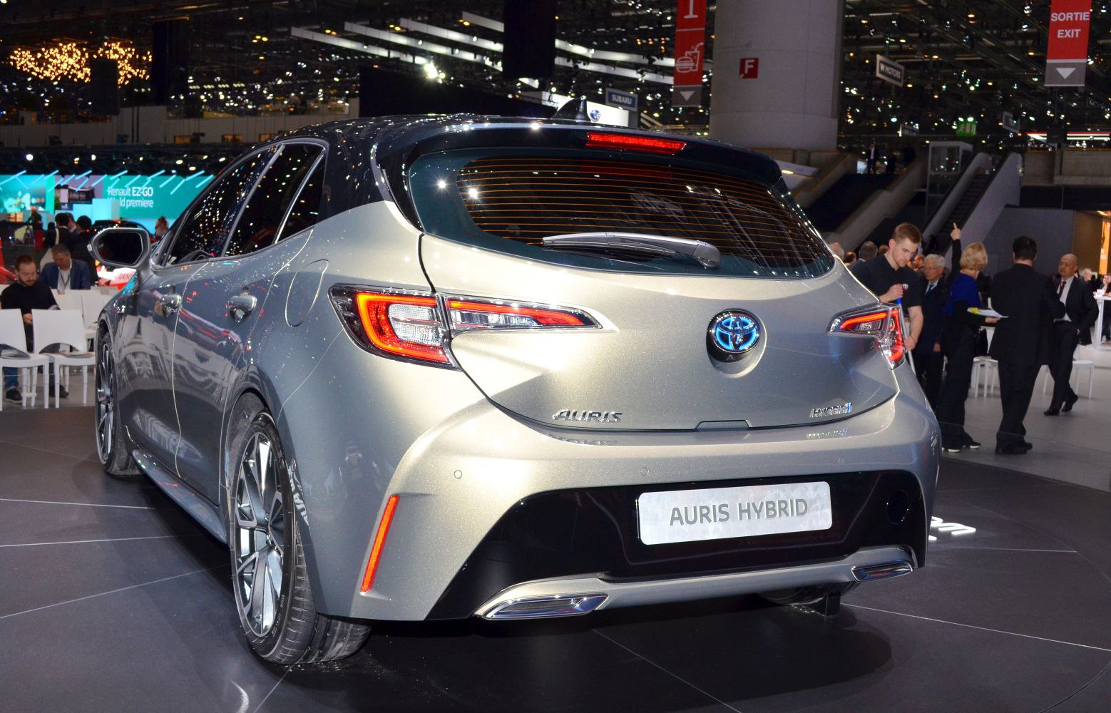 Rear view of a modern hatchback with LED tail lights and hybrid badging