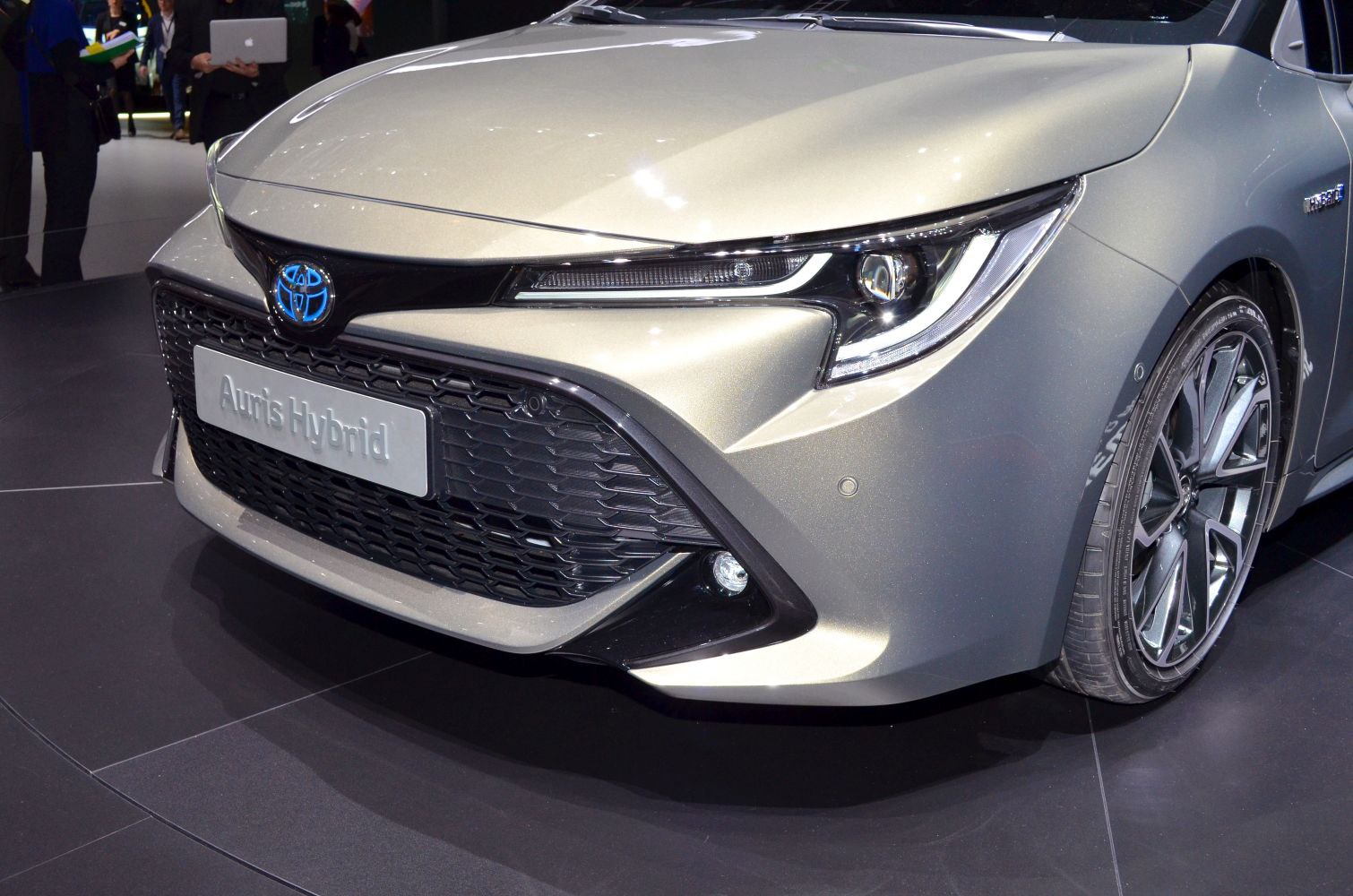 Sharp LED headlights and black mesh grille on hybrid vehicle front