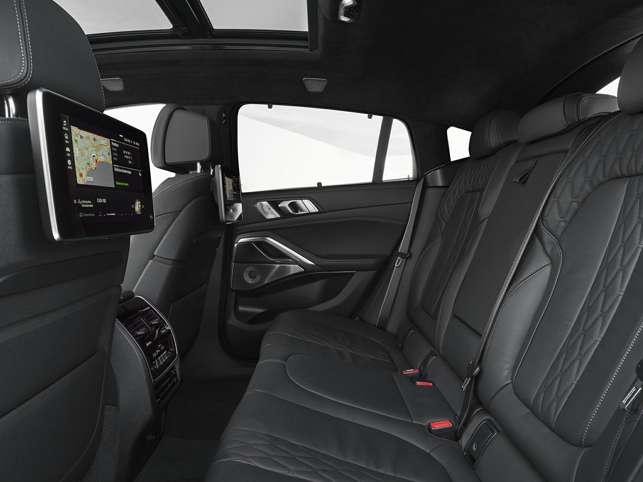 Luxurious rear interior with leather seats, dual screens, panoramic sunroof