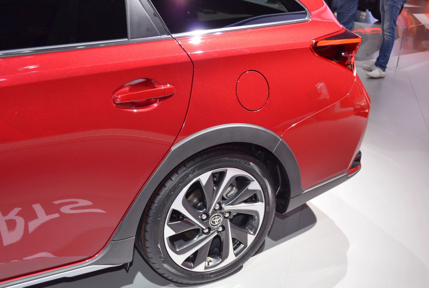 Close-up of rear side panel, fuel cap, and alloy wheel