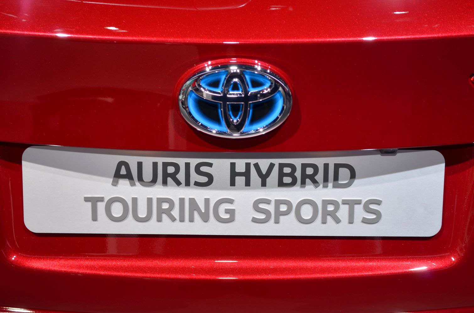 Close-up of Toyota emblem and Auris Hybrid Touring Sports badge